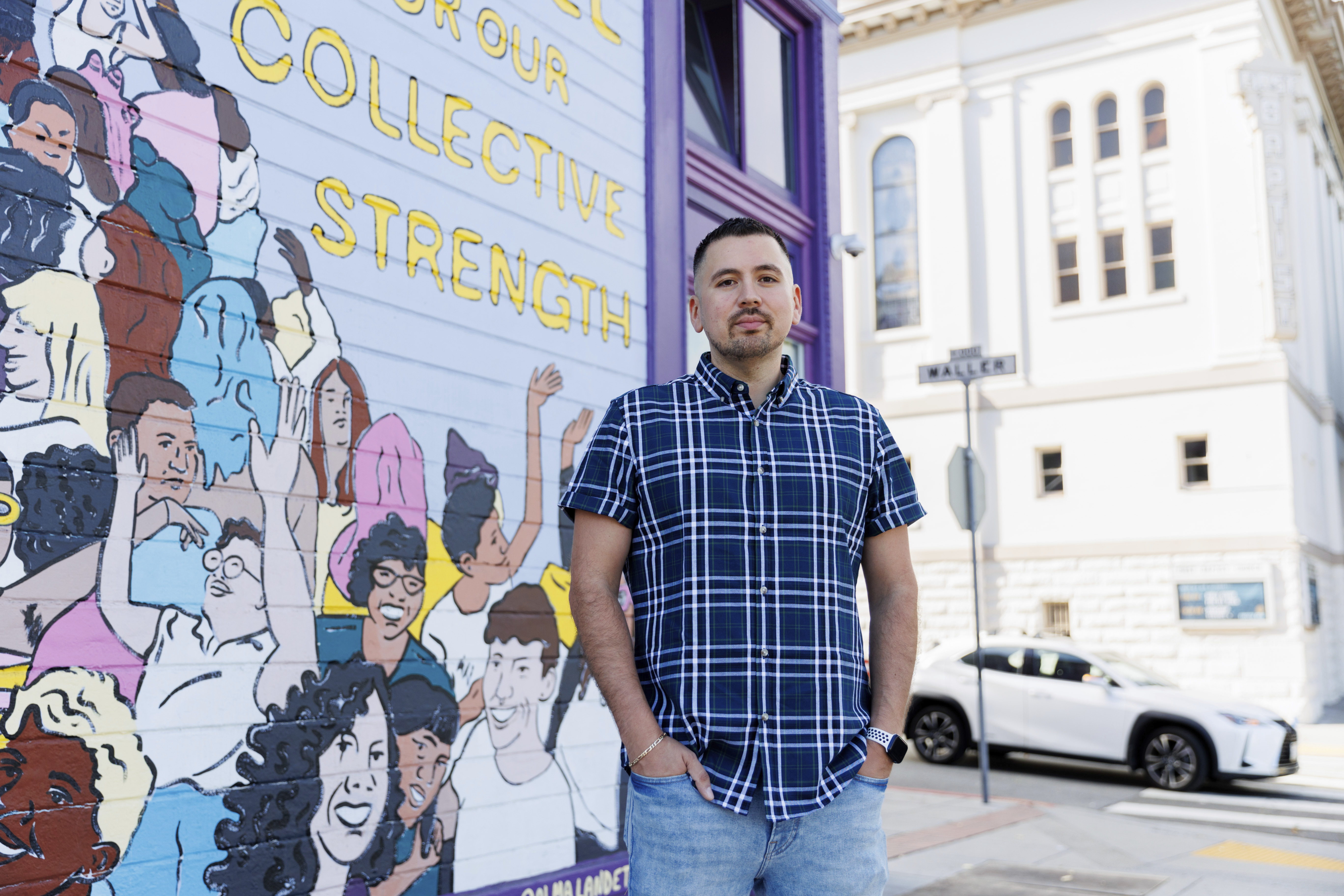 Luis A. Torres stands for a portrait in front of the " Joy is the Fuel" mural by Cuban-American artist Alma Landeta at the SF LGBT Center on Friday, Sept. 20, 2024, in San Francisco. (AP Photo/Juliana Yamada)