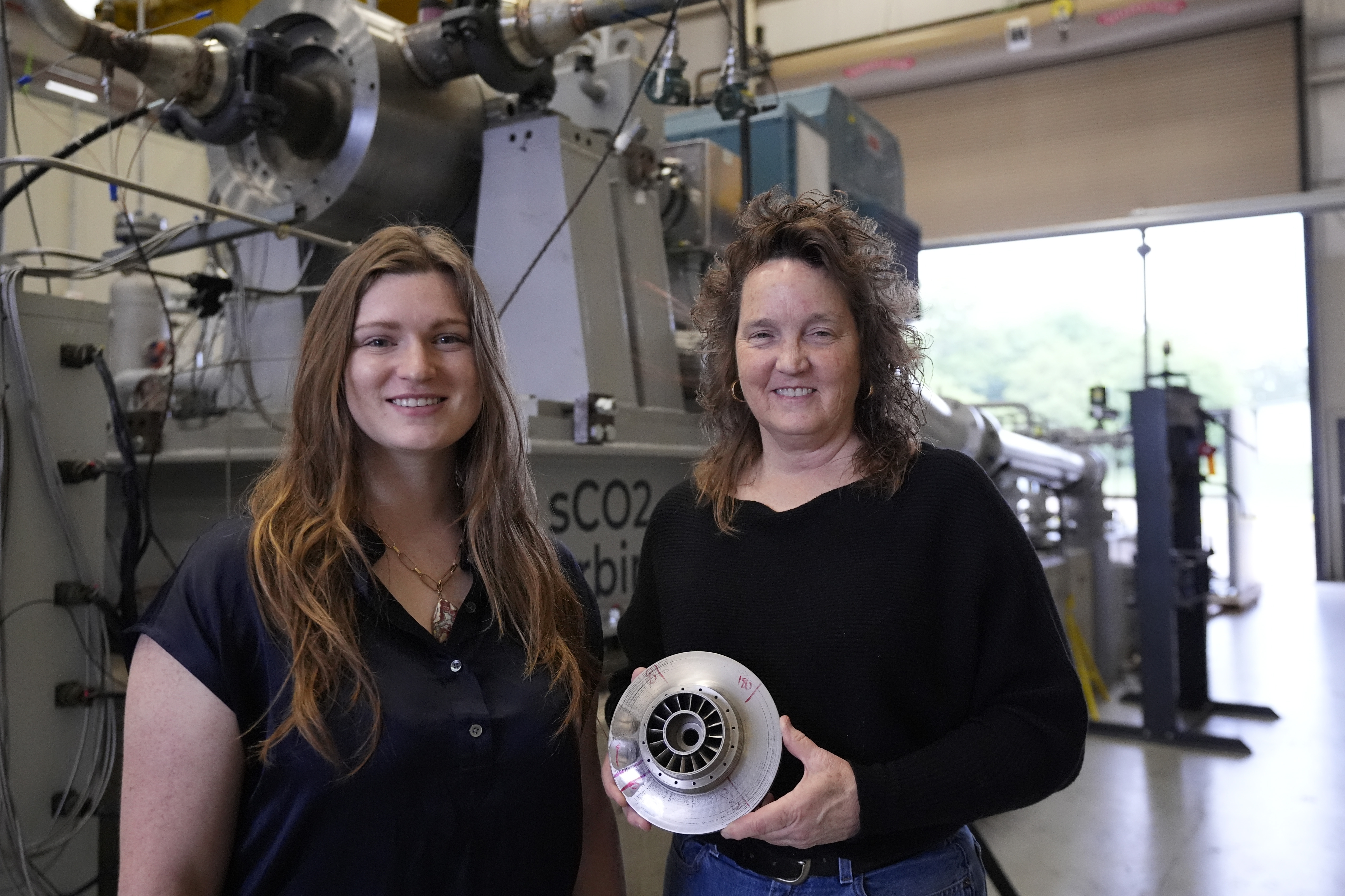 Cindy Taff, right, and Brianna Byrd, left, with Sage Geosystems, a startup that aims to make clean electricity, pose while visiting Southwest Research Institute where testing and research is taking place in San Antonio, Monday, April 1, 2024. (AP Photo/Eric Gay)