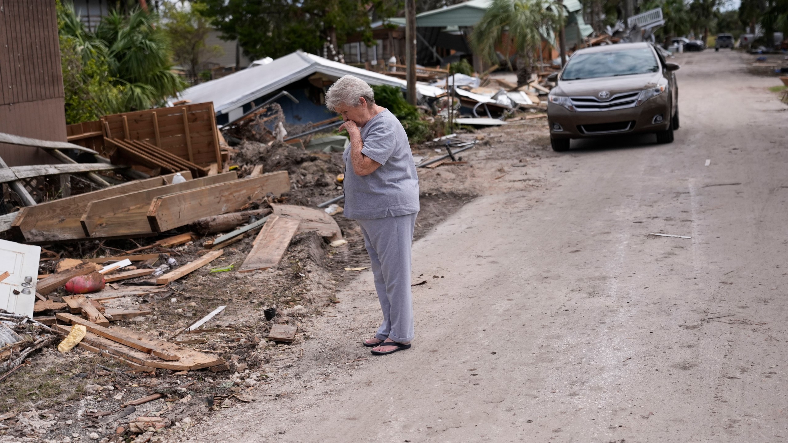 Elsie Hicks looks at the destruction of the home she has lived in for 25 years, in the aftermath of Hurricane Helene, in Horseshoe Beach, Fla., Saturday, Sept. 28, 2024. (AP Photo/Gerald Herbert)