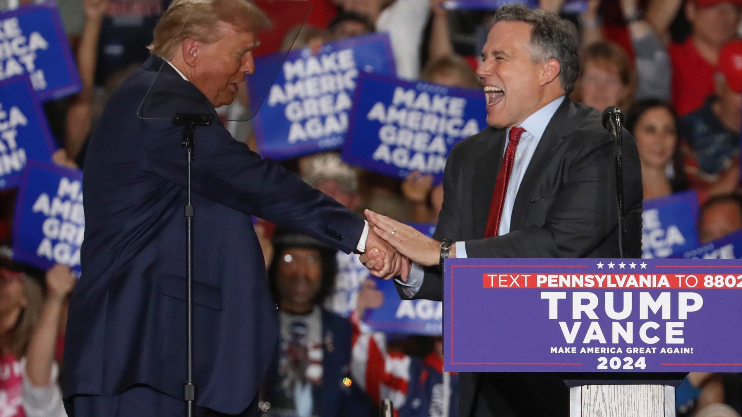 Republican presidential nominee former President Donald Trump shakes hands with Pennsylvania Senate candidate Dave McCormick at a campaign rally at Bayfront Convention Center in Erie, Pa., Sunday, Sept. 29, 2024. (AP Photo/Rebecca Droke)