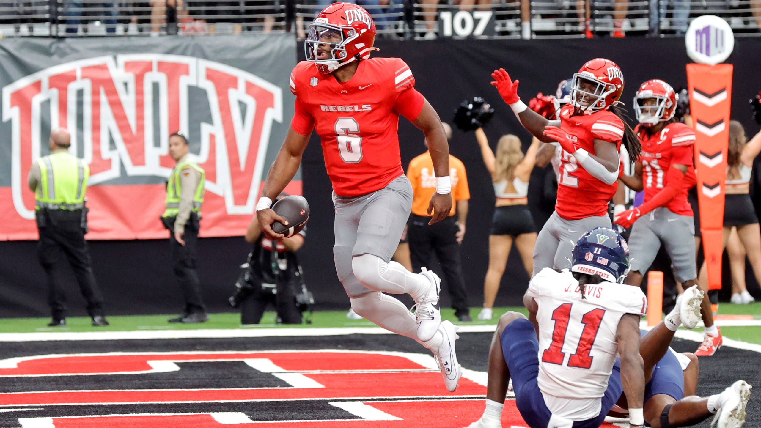 CORRECTS ID TO QUARTERBACK HAJJ-MALIK WILLIAMS, NOT RUNNING BACK JAI'DEN THOMAS - UNLV quarterback Hajj-Malik Williams (6) celebrates after running for a touchdown past Fresno State defensive back Jayden Davis (11) during the first half of a NCAA football game, Saturday, Sept. 28, 2024, in Las Vegas. (Steve Marcus/Las Vegas Sun via AP)