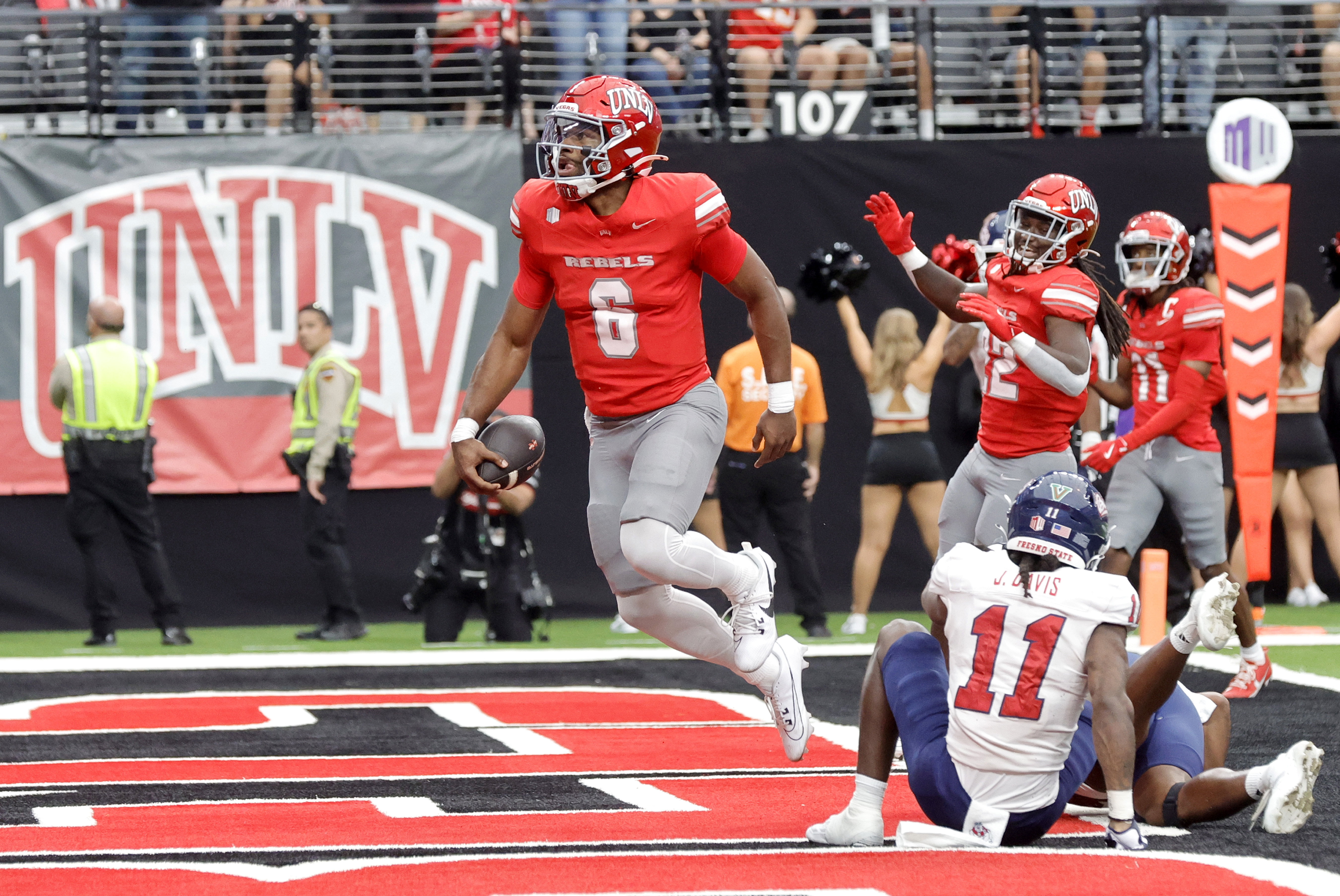 CORRECTS ID TO QUARTERBACK HAJJ-MALIK WILLIAMS, NOT RUNNING BACK JAI'DEN THOMAS - UNLV quarterback Hajj-Malik Williams (6) celebrates after running for a touchdown past Fresno State defensive back Jayden Davis (11) during the first half of a NCAA football game, Saturday, Sept. 28, 2024, in Las Vegas. (Steve Marcus/Las Vegas Sun via AP)