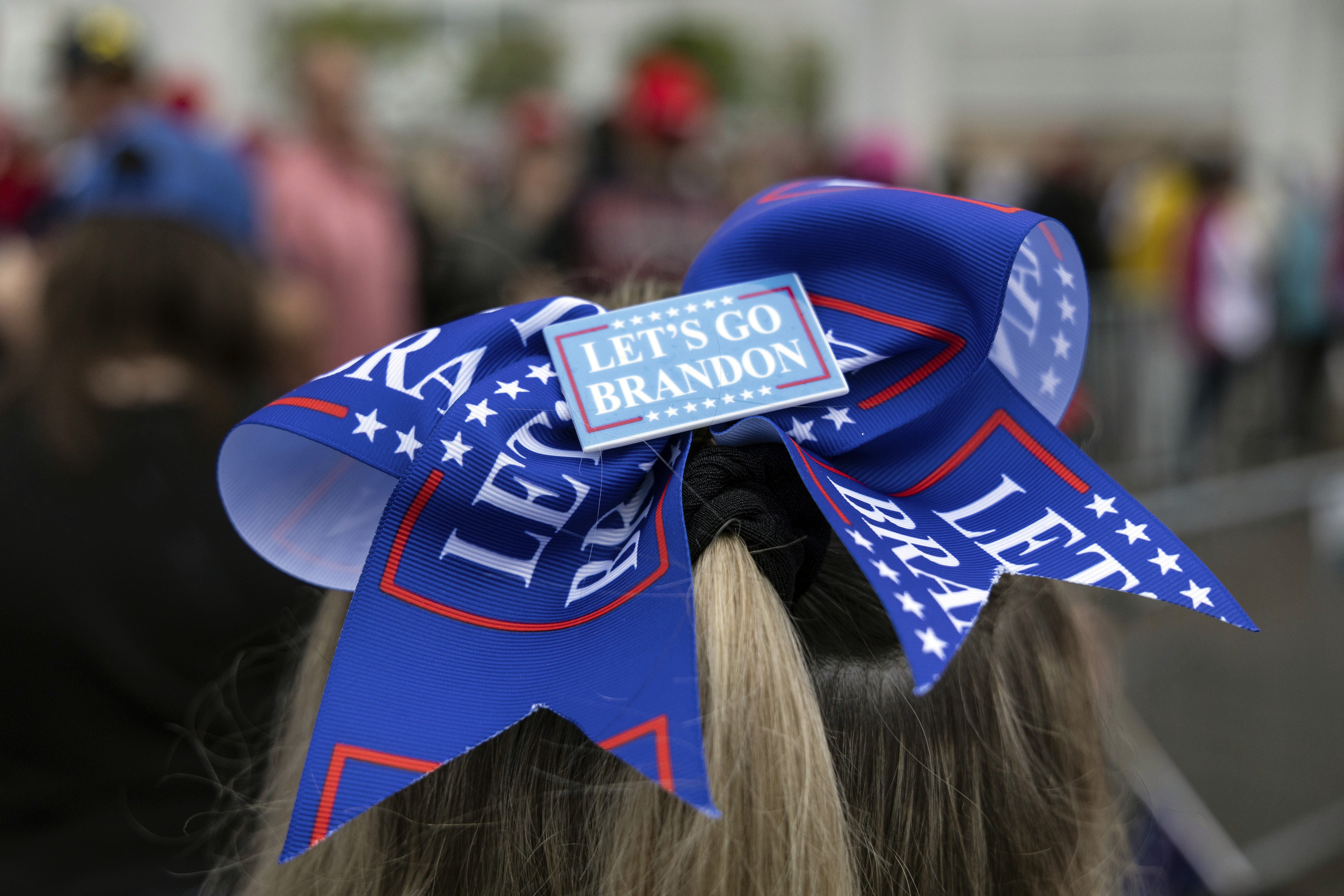 A woman waits in line to enter the Bayfront Convention Center before the doors open for an afternoon campaign rally with Republican presidential nominee former President Donald Trump in Erie, Pa., Sunday, Sept. 29, 2024. (AP Photo/Rebecca Droke)