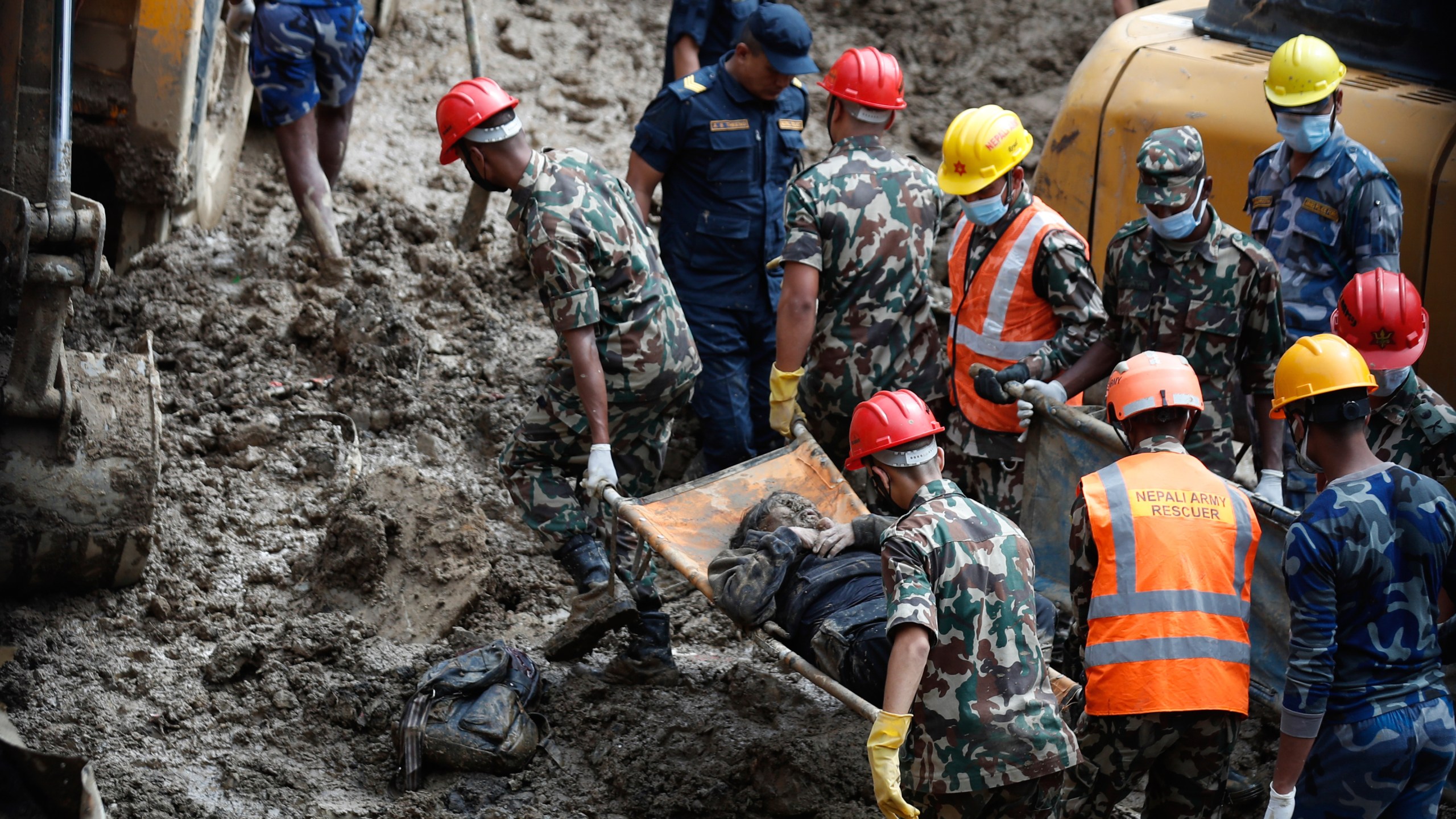 EDS NOTE: GRAPHIC CONTENT - Rescue personnel transport the dead body of a victim who was trapped under a landslide caused by heavy rains in Kathmandu, Nepal, Sunday, Sept. 29, 2024. (AP Photo/Sujan Gurung)