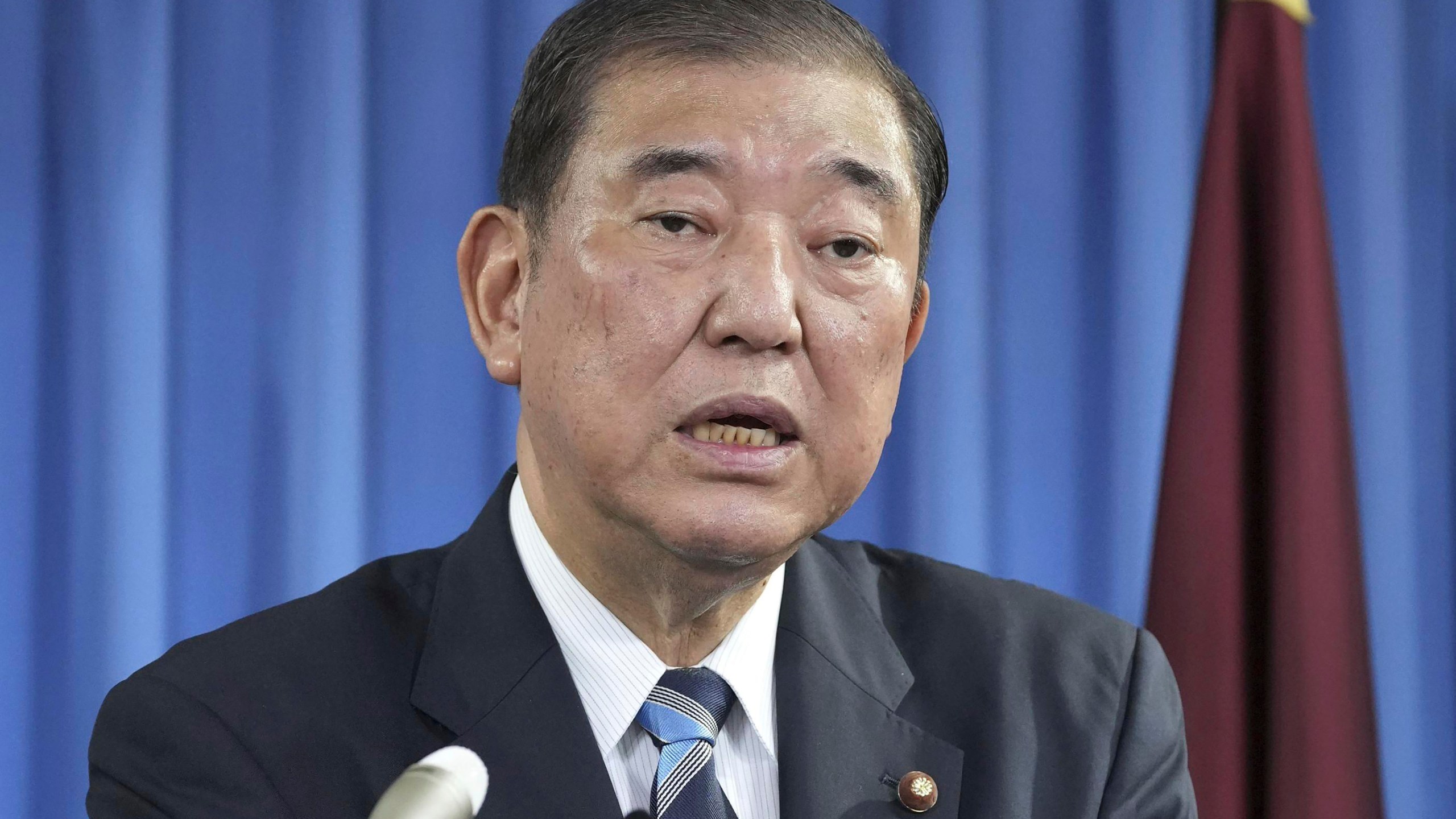 Shigeru Ishiba, the head of Japan's governing party, the Liberal Democratic Party speaks during a press conference at the party's headquarters in Tokyo Monday, Sept. 30, 2024 to announce that he plans to call a parliamentary election on Oct. 27 after he is formally elected as prime minister. (Kyodo News via AP)