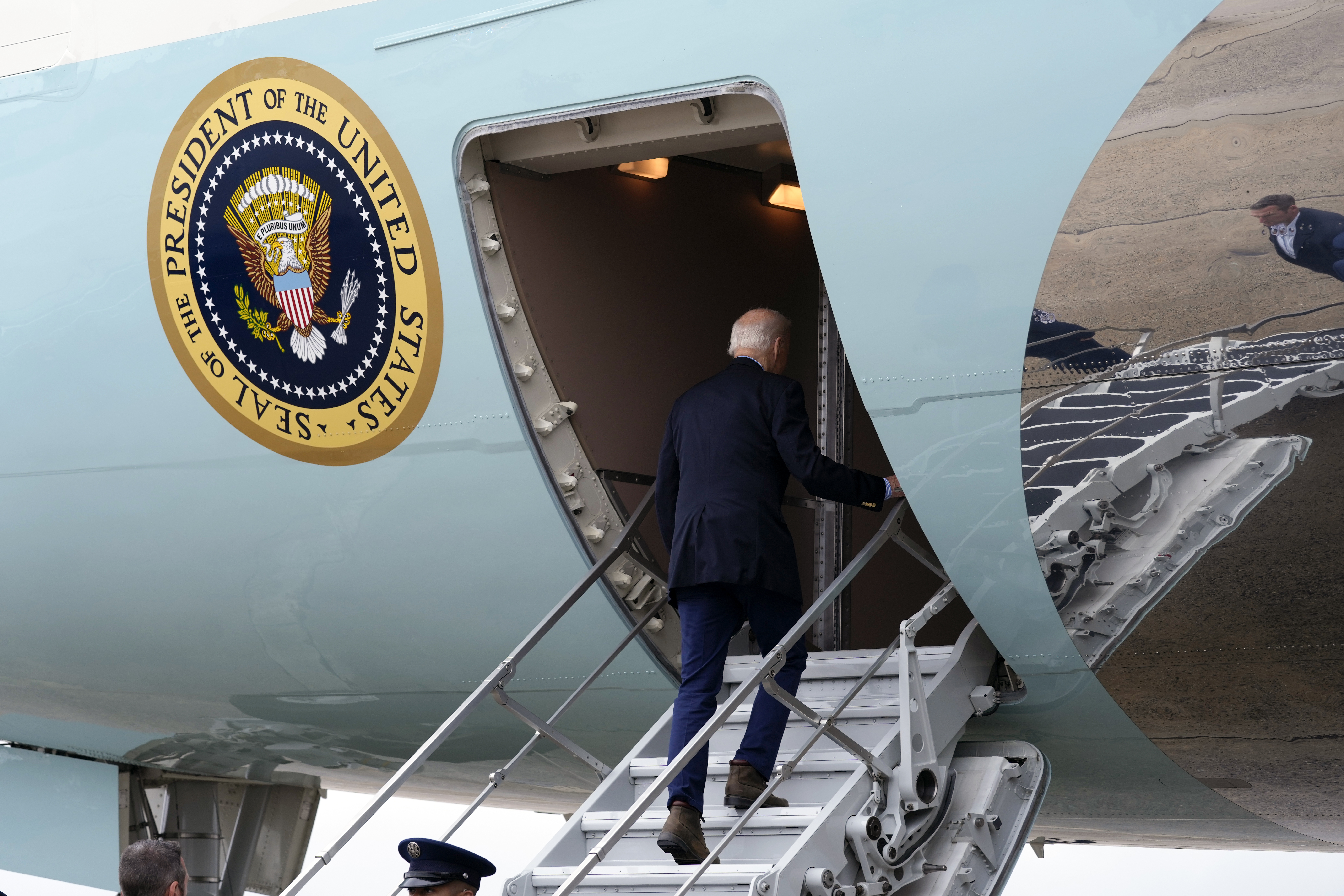 President Joe Biden walks up the steps and boards Air Force One at Joint Base Andrews, Md., Wednesday, Oct. 2, 2024, as he heads to North and South Carolina to survey damage from Hurricane Helene. (AP Photo/Susan Walsh)