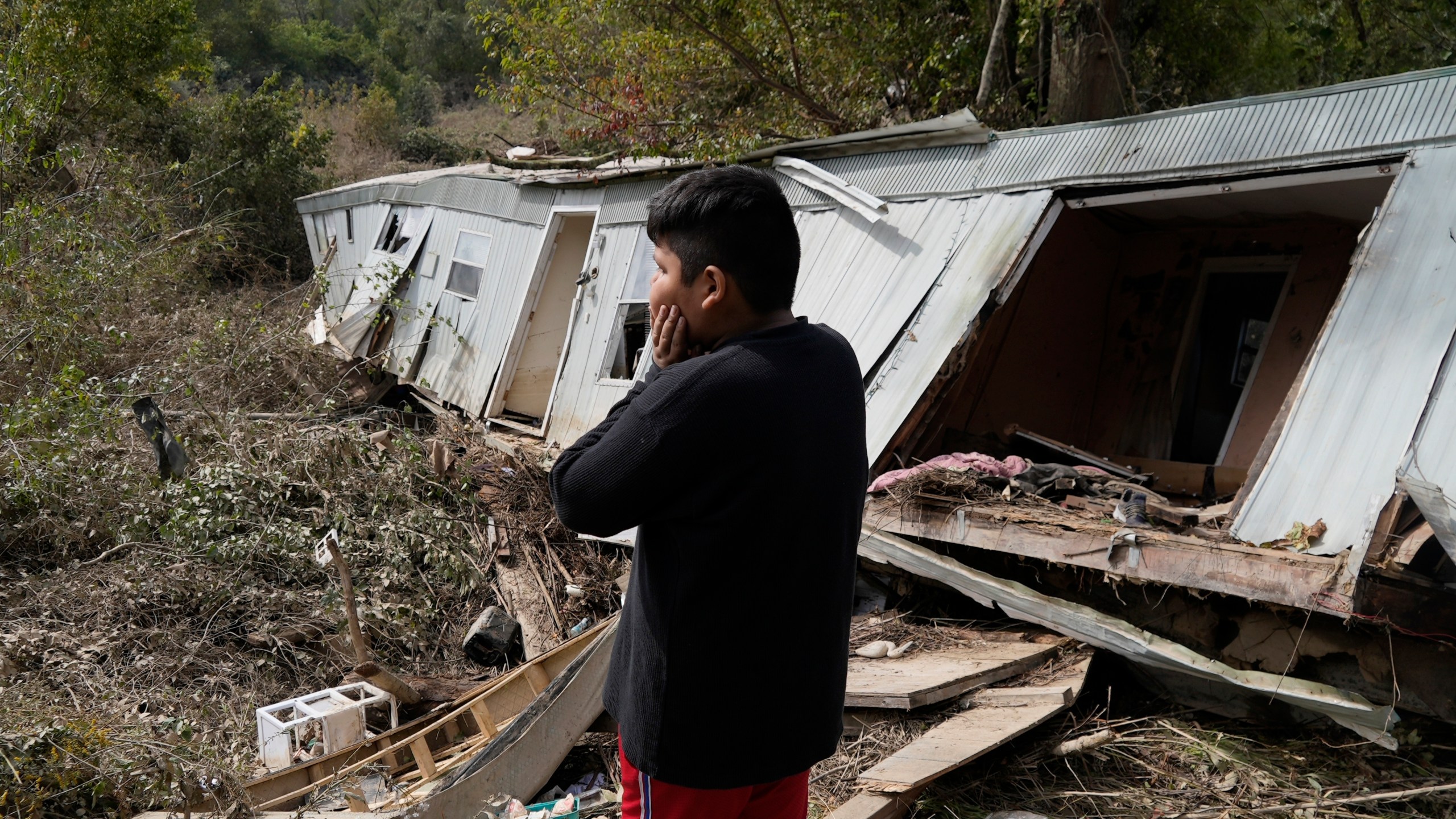 FILE - Gerardo Hernandez Juarez stares at what is left of his family's destroyed home, Oct. 1, 2024, in Hendersonville, N.C., in the aftermath of Hurricane Helene. (AP Photo/Brittany Peterson, File)