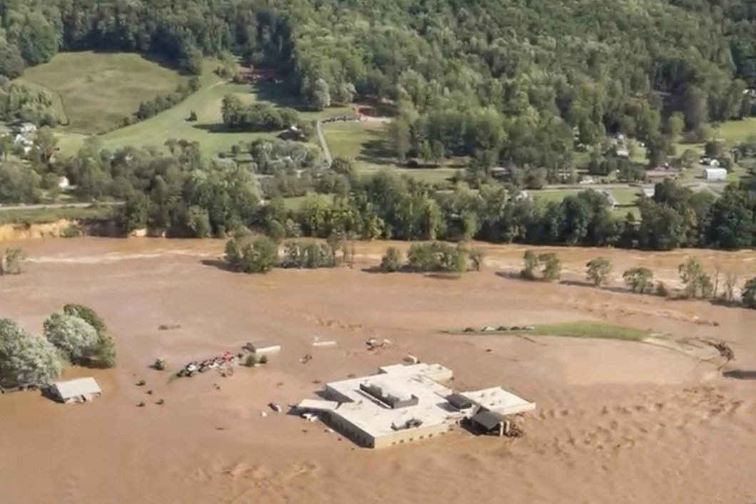 This image taken from video from the Tennessee Emergency Management Agency shows a helicopter on the roof of Unicoi County Hospital in Erwin, Tenn., where patients and staff had to be rescued from after the Nolichucky River flooded and surrounded the building from Hurricane Helene, Friday, Sept. 27, 2024. (Tennessee Emergency Management Agency via AP)