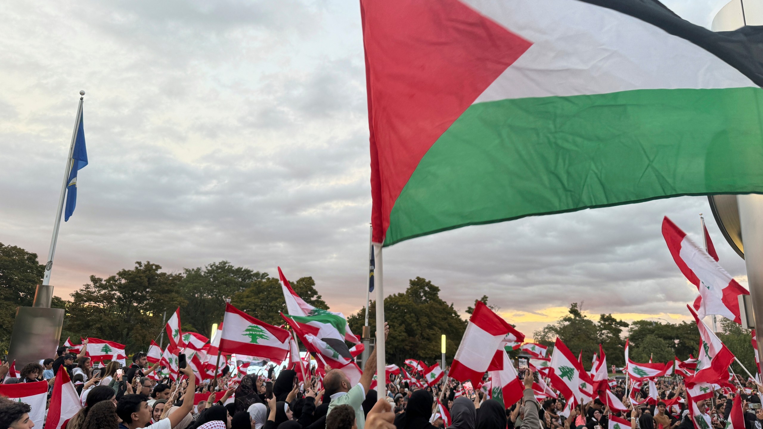 Hundreds of Lebanese and Palestinian flags are flown throughout a crowd in Dearborn, Mich. on Wednesday, Sept. 25, 2024 as people attend a rally to show their support for Lebanon as the conflict in the Middle East escalates. (AP Photo/Joey Cappelletti)