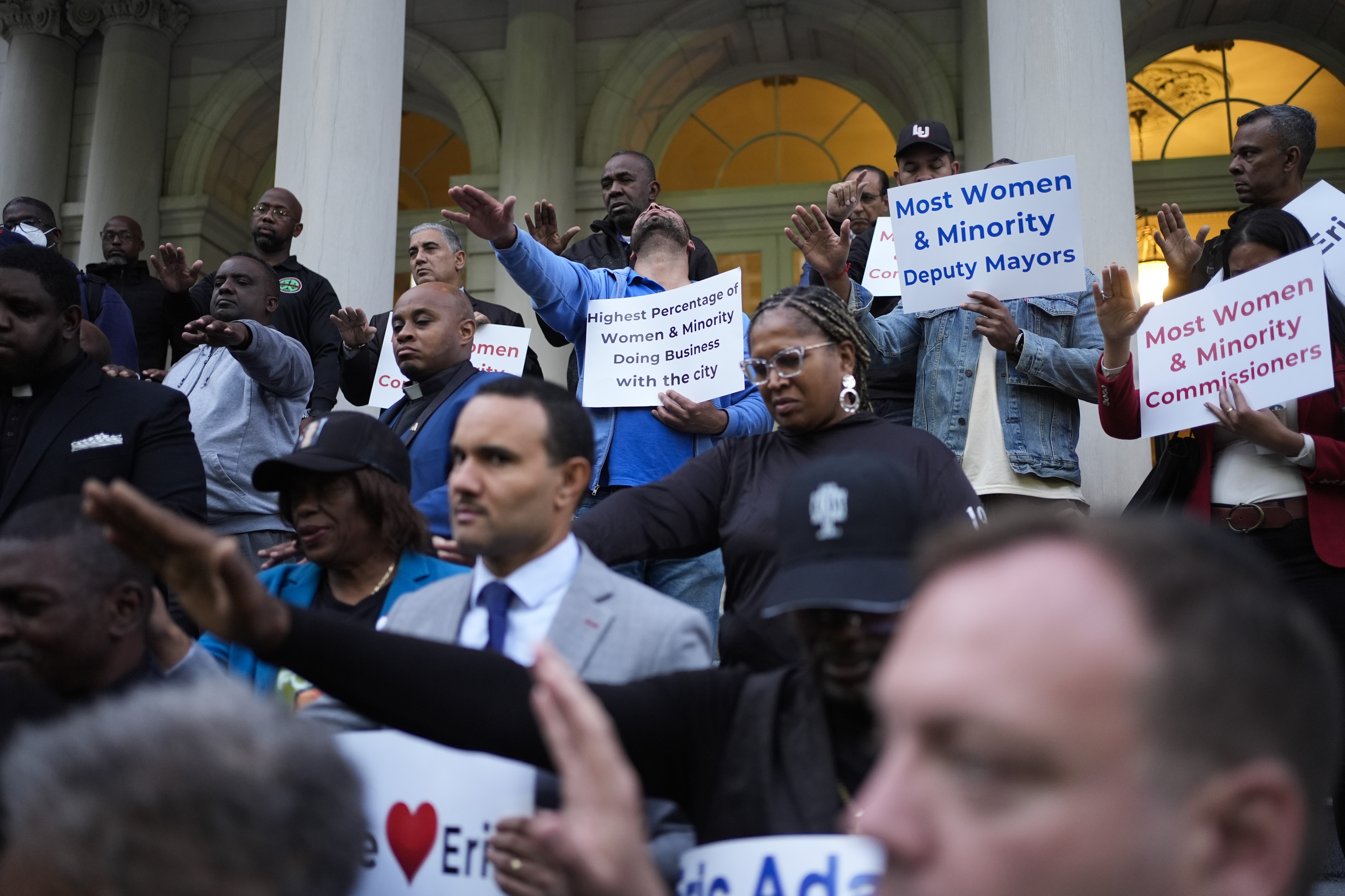 Faith leaders and other supporters pray over New York City Mayor Eric Adams during a rally and prayer vigil on the steps of City Hall in New York, Tuesday, Oct. 1, 2024. (AP Photo/Seth Wenig)