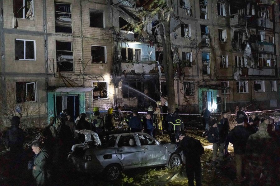 Rescue workers clear the rubble of a building damaged by a Russian airstrike in Kharkiv, Ukraine, Wednesday Oct. 2, 2024. (AP Photo/Yevhen Titov)