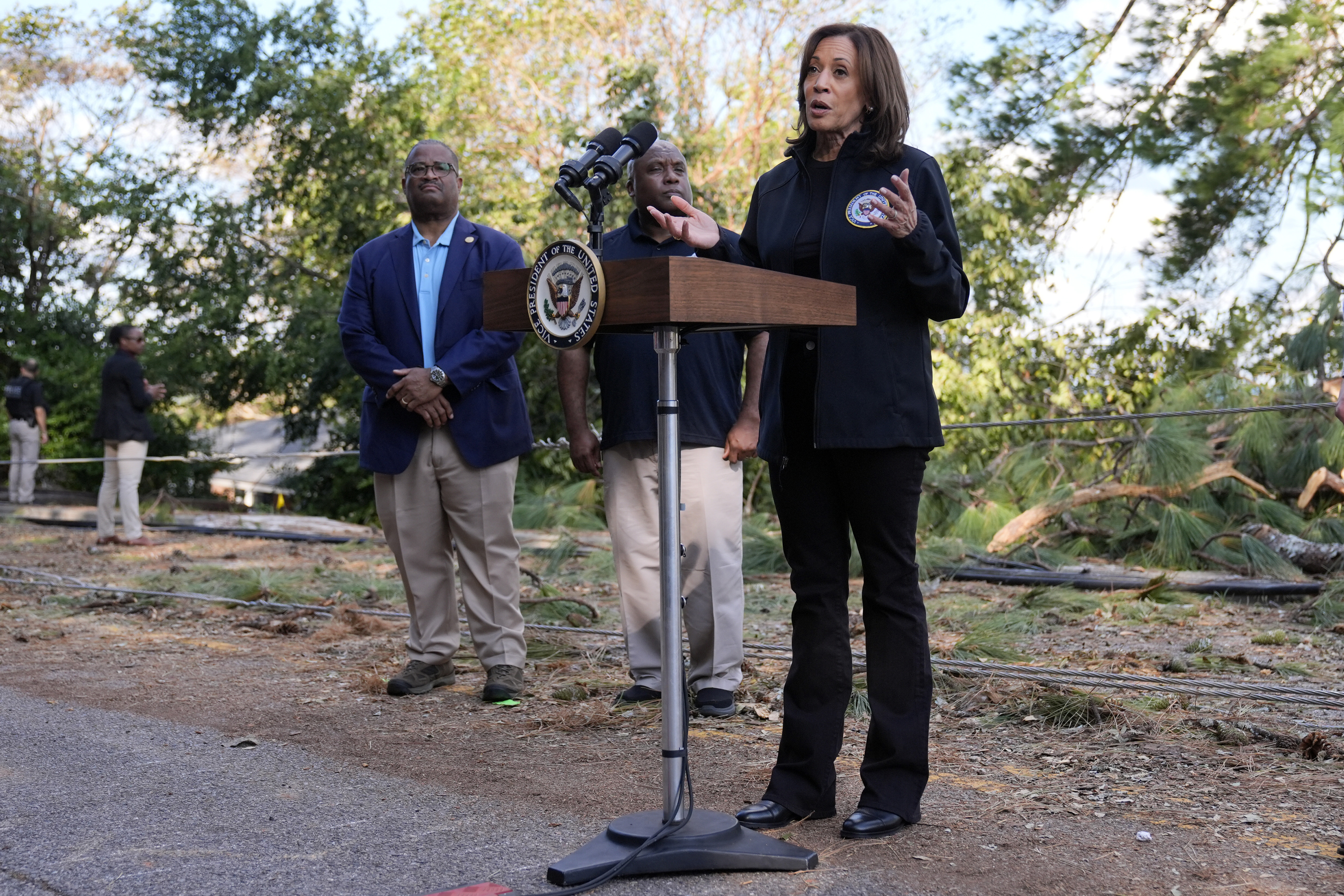 Democratic presidential nominee Vice President Kamala Harris speaks as she tours an area impacted by Hurricane Helene in Augusta, Ga., Wednesday, Oct. 2, 2024, as Augusta Mayor Garnett Johnson, left, and FEMA deputy administrator Erik Hooks listen. (AP Photo/Carolyn Kaster)