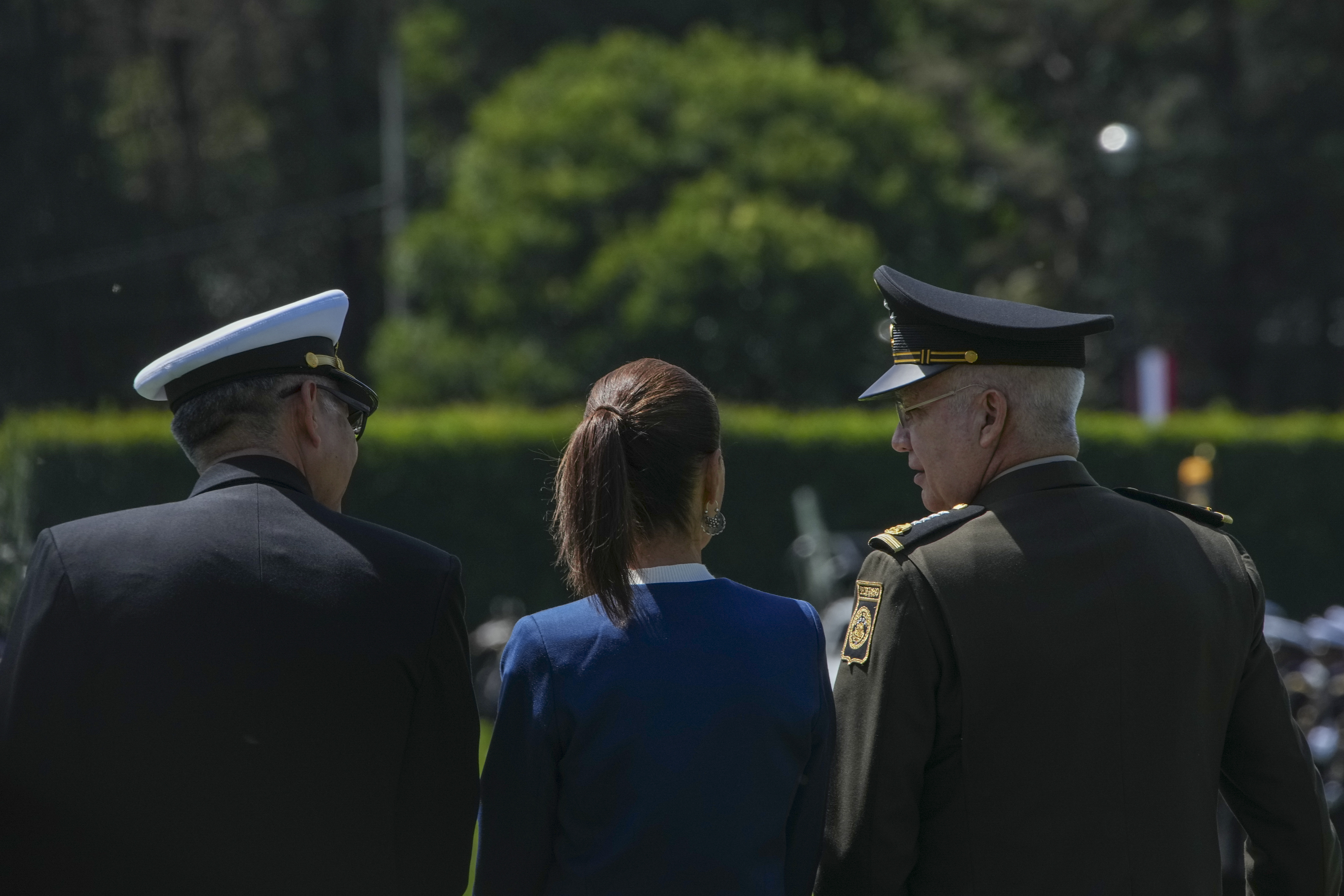 Mexican President Claudia Sheinbaum, center, reviews the troops with Defense Minister Gen. Ricardo Trevilla Trejo, right, and Navy Secretary Alt. Raymundo Pedro Morales at Campo Marte in Mexico City, Thursday, Oct. 3, 2024. (AP Photo/Fernando Llano)