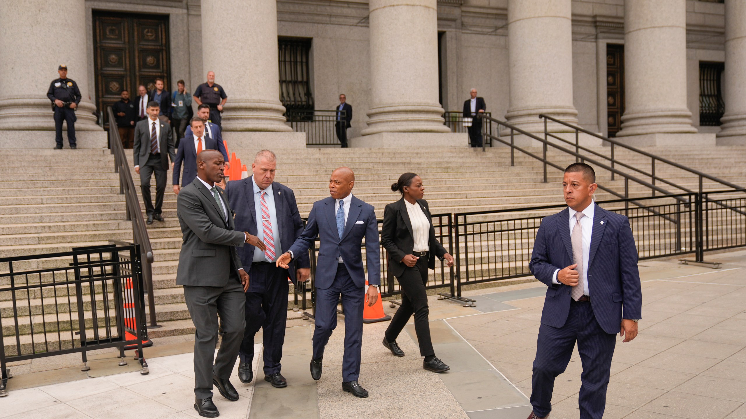 New York City Mayor Eric Adams, center, leaves the courthouse in New York, Wednesday, Oct. 2, 2024. (AP Photo/Seth Wenig)