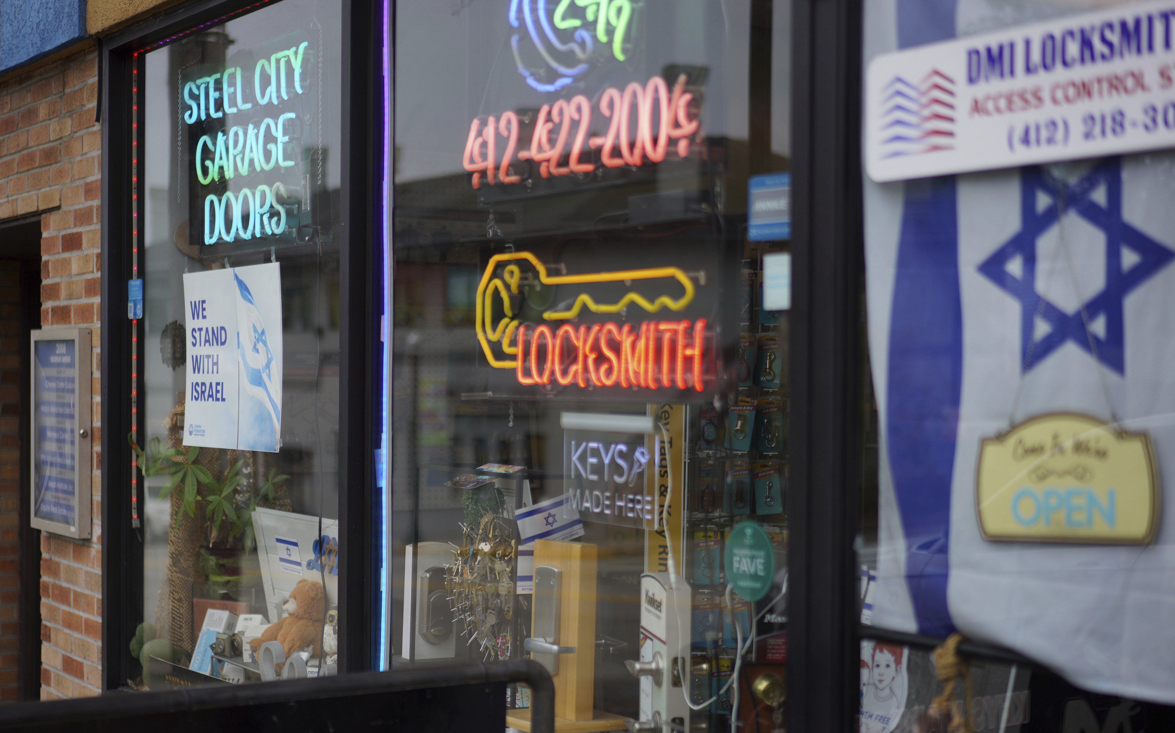 A local business in the Squirrel Hill neighborhood, the heart of Pittsburgh's Jewish community, displays an Israeli flag and signs in solidarity with Israel in its shop windows, Friday, Sept. 27, 2024, in Pittsburgh. (AP Photo/Jessie Wardarski)