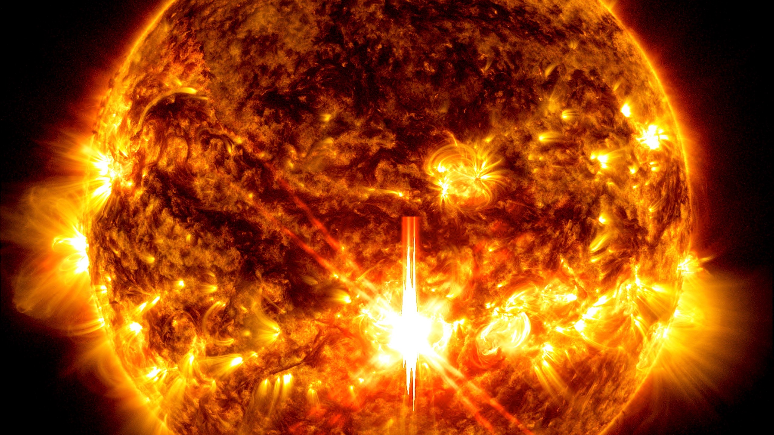 This photo provided by NASA, taken by the Solar Dynamics Observatory, shows a solar flare, the bright flash in the center of the image on Oct. 3, 2024. (Solar Dynamics Observatory/NASA via AP)