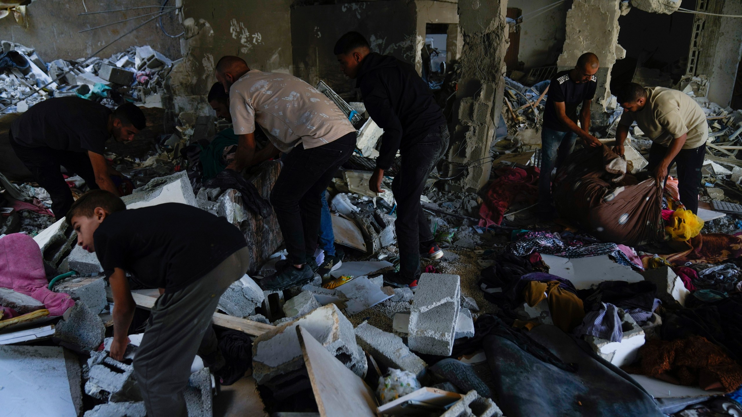 Palestinians examine the damage following an Israeli airstrike in the West Bank city of Tulkarem, which Palestinian health officials say killed 18 people and the Israeli military says took out a Hamas leader, on Friday, Oct. 4, 2024. (AP Photo/Nasser Nasser)