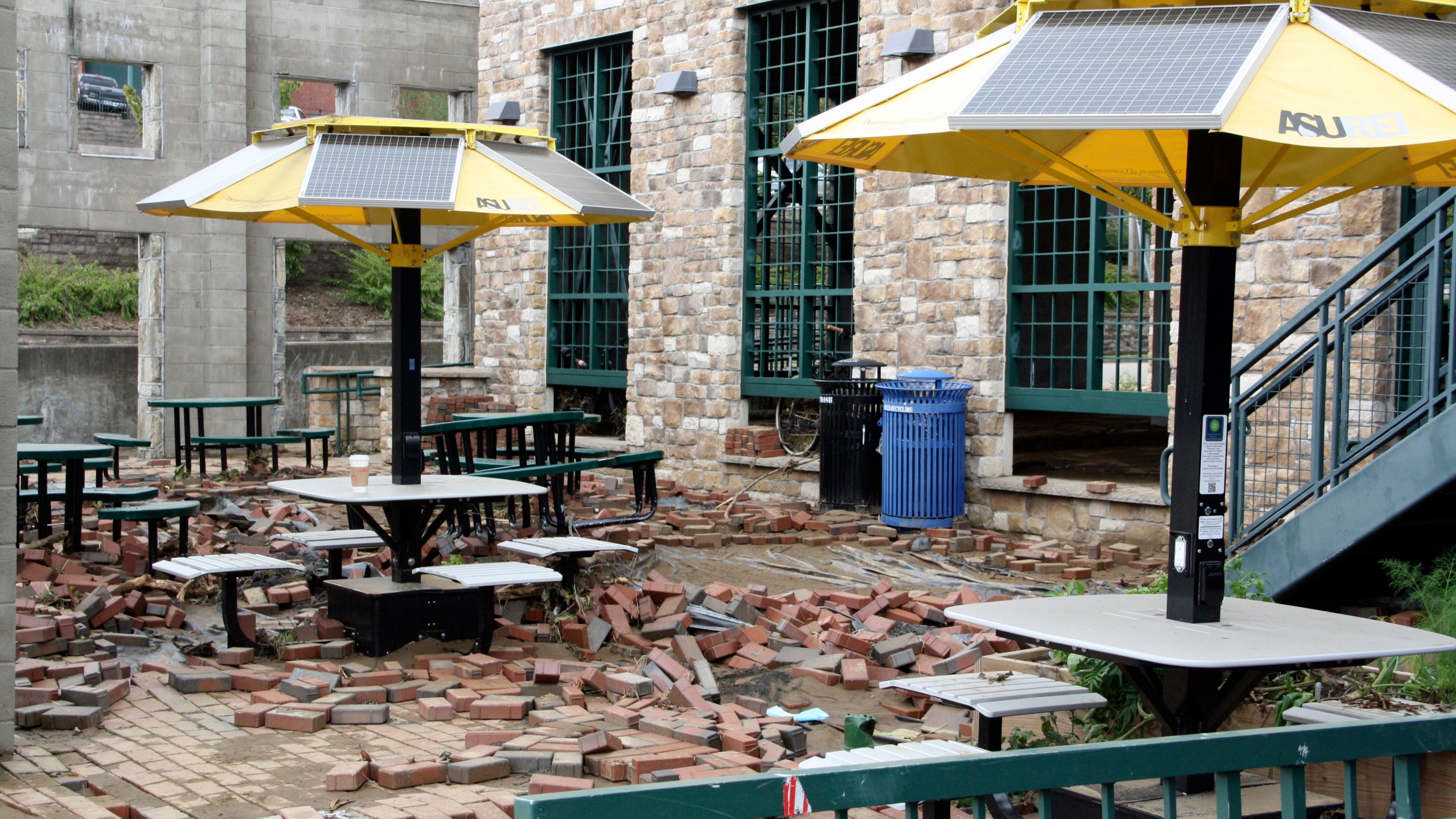 Bricks lie scattered from the destruction and flooding of Tropical Storm Helene at an outdoor seating area in downtown Boone, N.C., on Monday, Sept. 30, 2024. (AP Photo/Makiya Seminera)