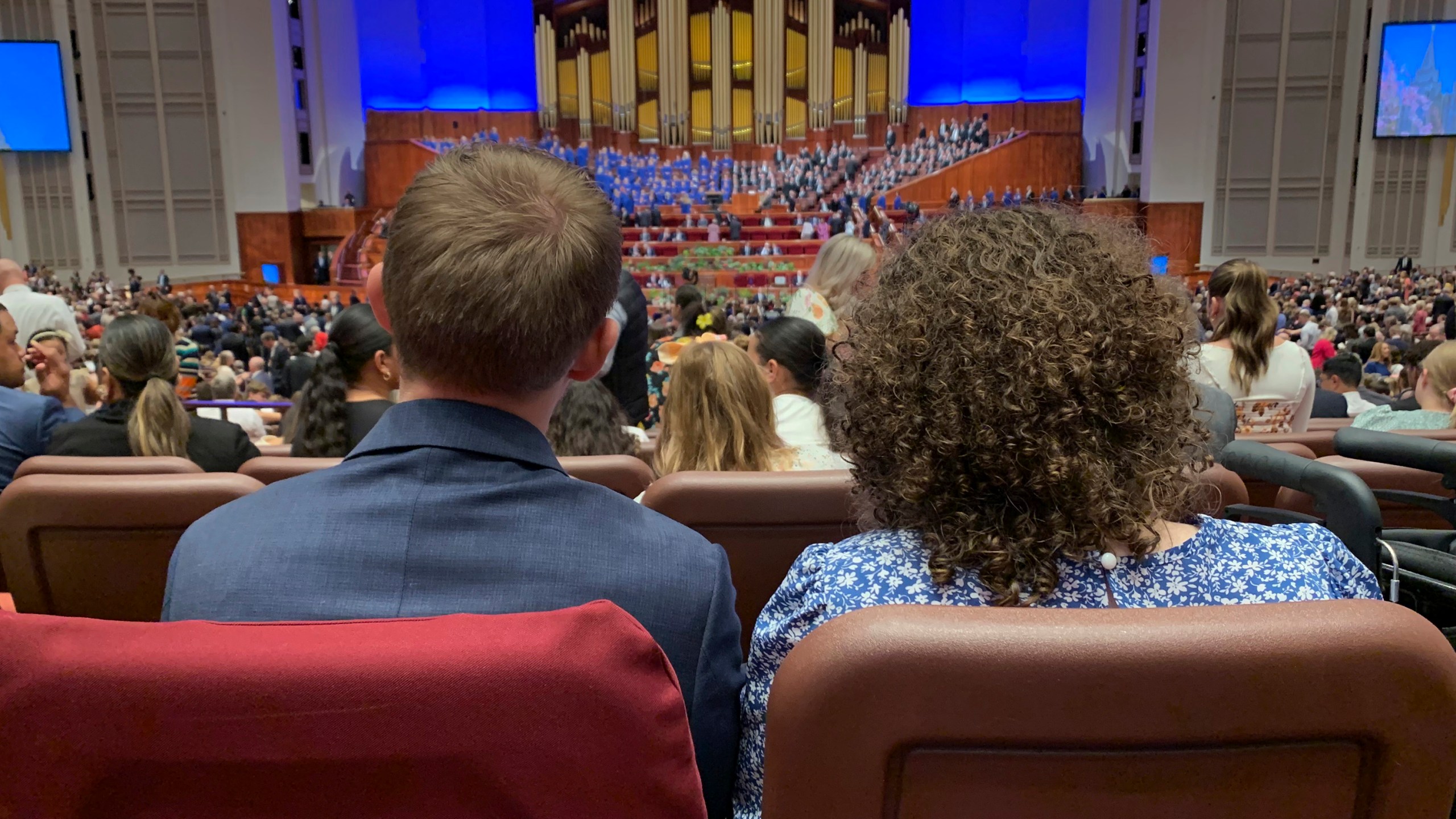 Ben Winkel, left, and his wife Jenna Winkel wait for The Church of Jesus Christ of Latter-day Saints twice-annual general conference to begin on Saturday, Oct. 5, 2024, in Salt Lake City, Utah. (AP Photo/Hannah Schoenbaum)