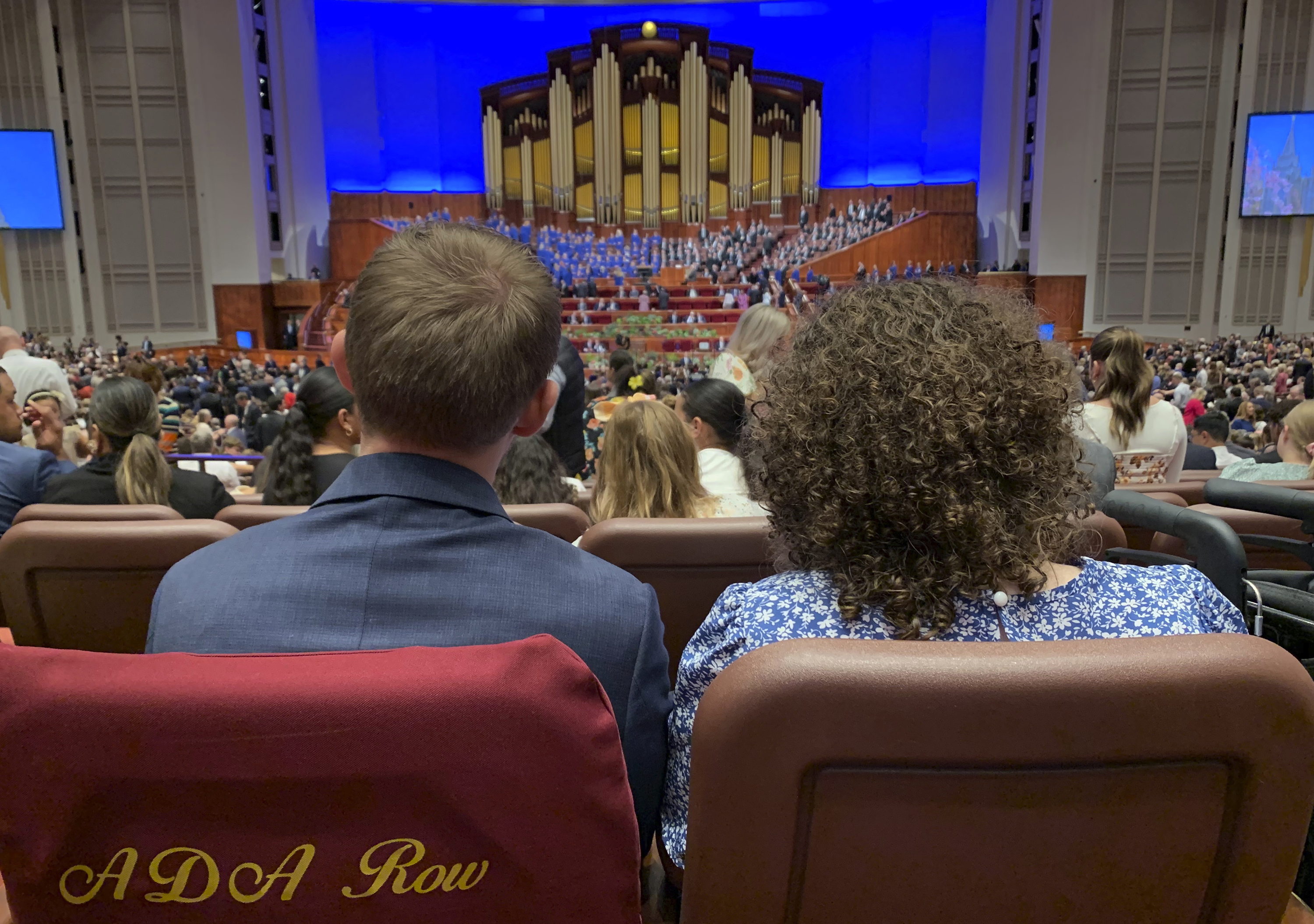 Ben Winkel, left, and his wife Jenna Winkel wait for The Church of Jesus Christ of Latter-day Saints twice-annual general conference to begin on Saturday, Oct. 5, 2024, in Salt Lake City, Utah. (AP Photo/Hannah Schoenbaum)