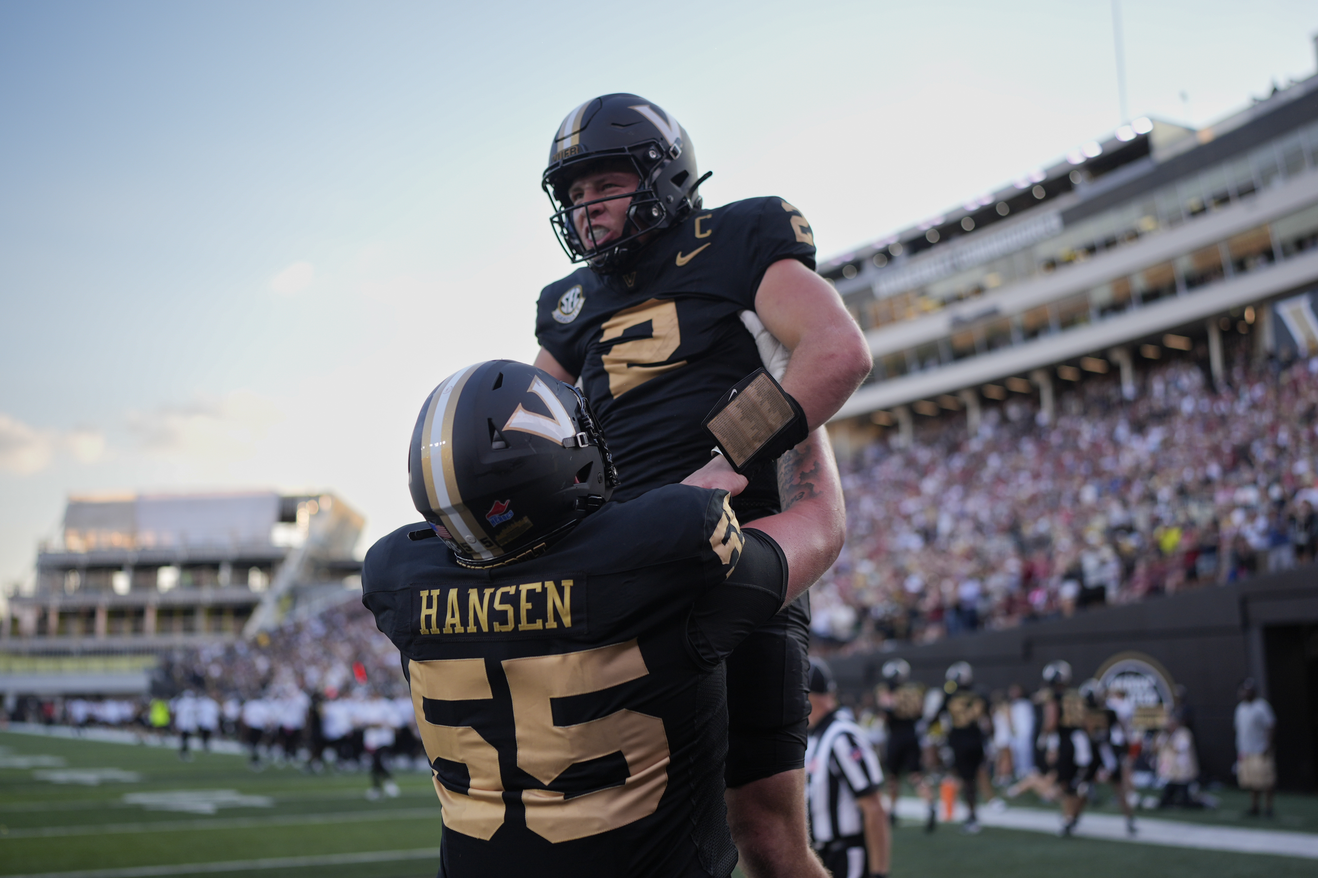 Vanderbilt quarterback Diego Pavia (2) celebrates a touchdown with offensive lineman Gunnar Hansen (55) during the second half of an NCAA college football game against Alabama, Saturday, Oct. 5, 2024, in Nashville, Tenn. (AP Photo/George Walker IV)