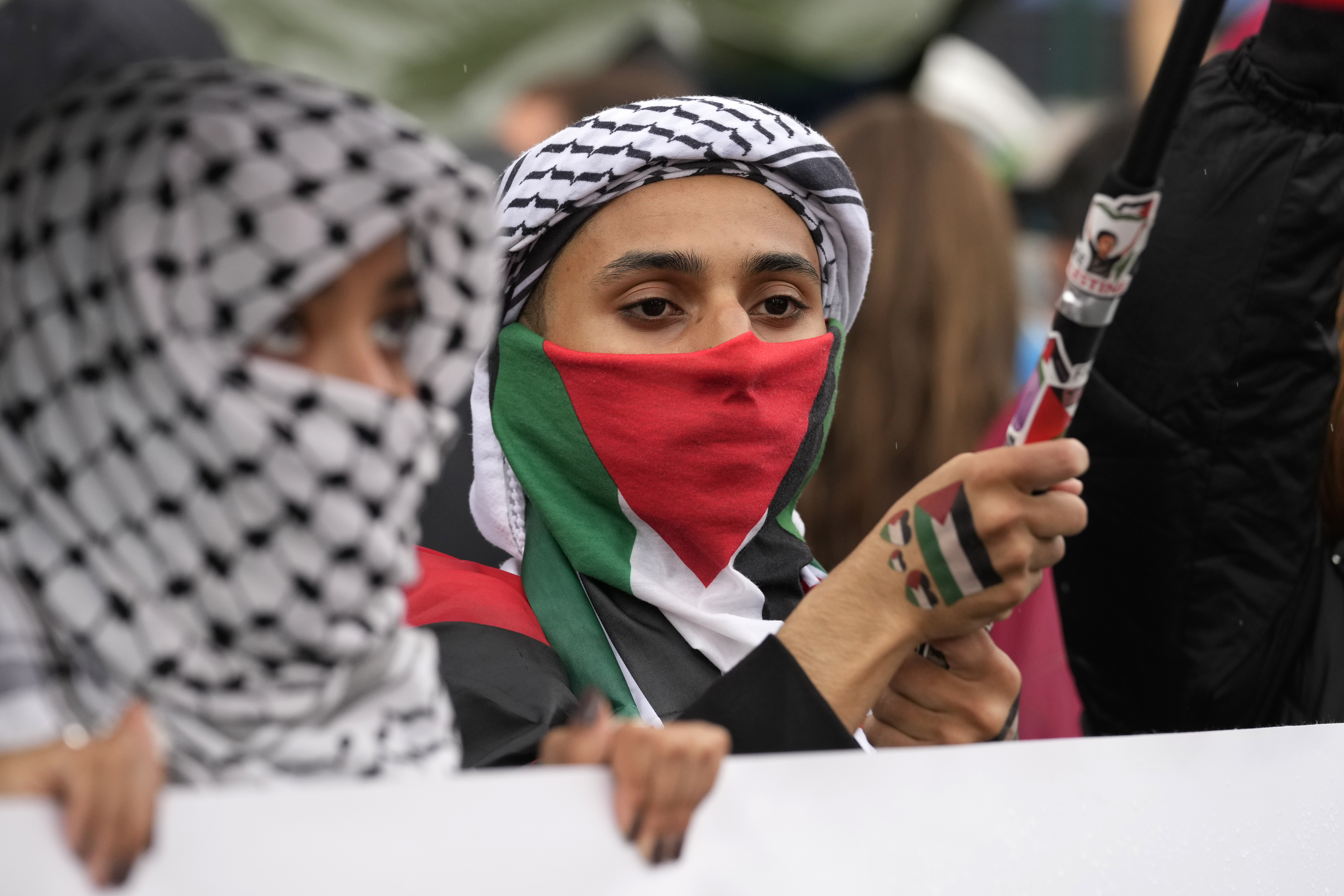 Women attend at a protest in Rome, Saturday, Oct. 5, 2024. Pro-palestinians people take to the street in an unauthorised march in the centre of Rome two days ahead of the first anniversary of the Oct. 7. (AP Photo/Andrew Medichini)