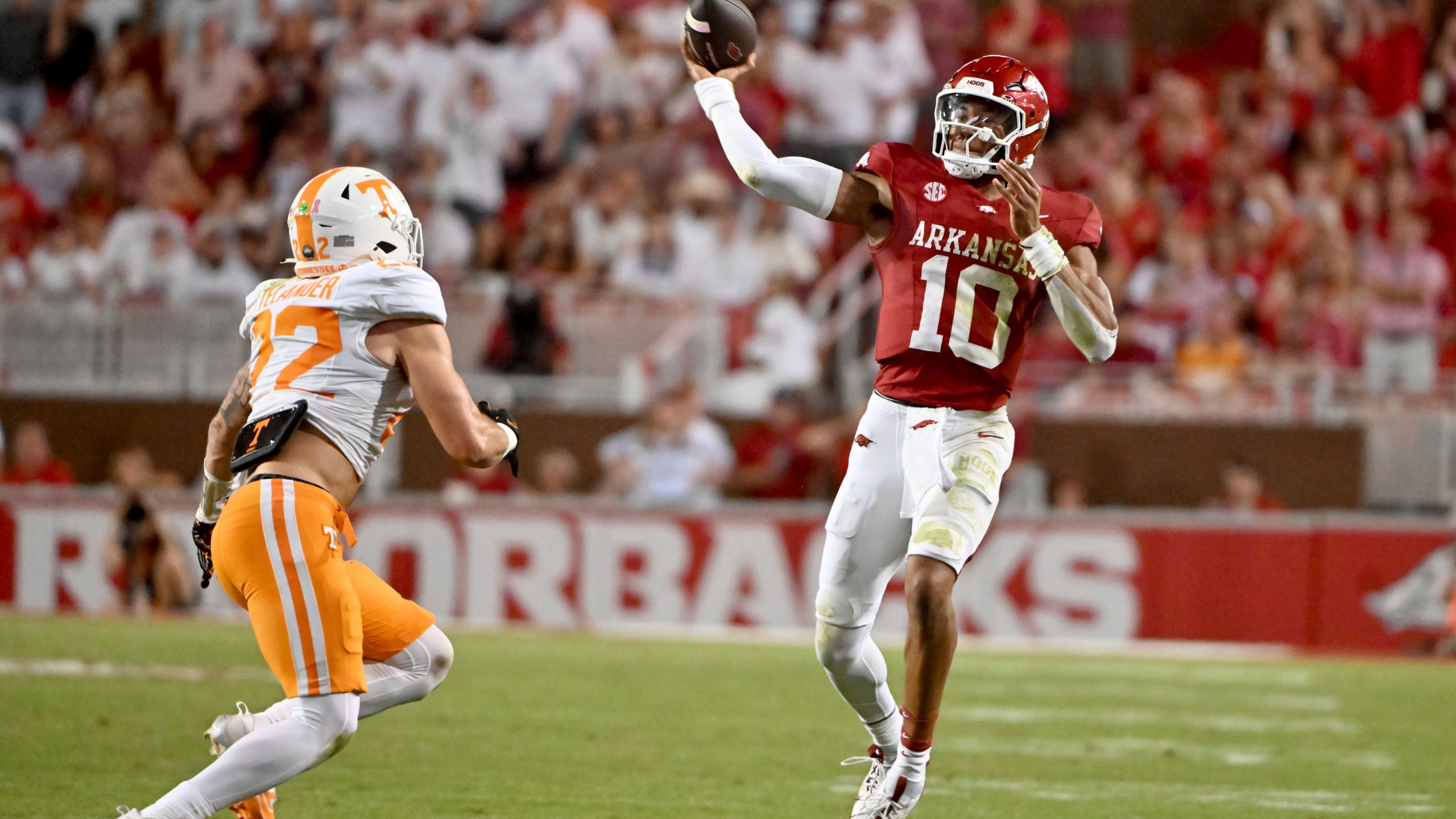 Arkansas quarterback Taylen Green (10) throws a pass over Tennessee linebacker Jeremiah Telander (22) during the first half of an NCAA college football game, Saturday, Oct. 5, 2024, in Fayetteville, Ark. (AP Photo/Michael Woods)