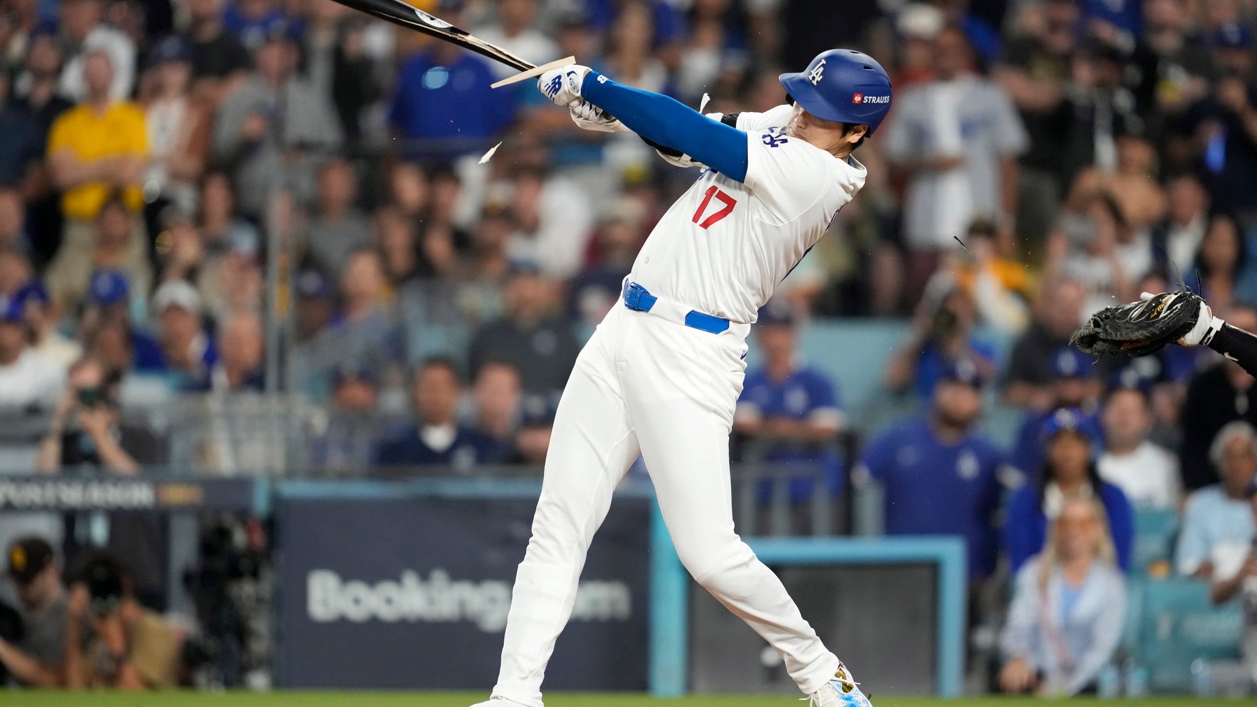 Los Angeles Dodgers' Shohei Ohtani breaks his bat as he singles during the fourth inning in Game 1 of baseball's NL Division Series against the San Diego Padres, Saturday, Oct. 5, 2024, in Los Angeles. (AP Photo/Ashley Landis)