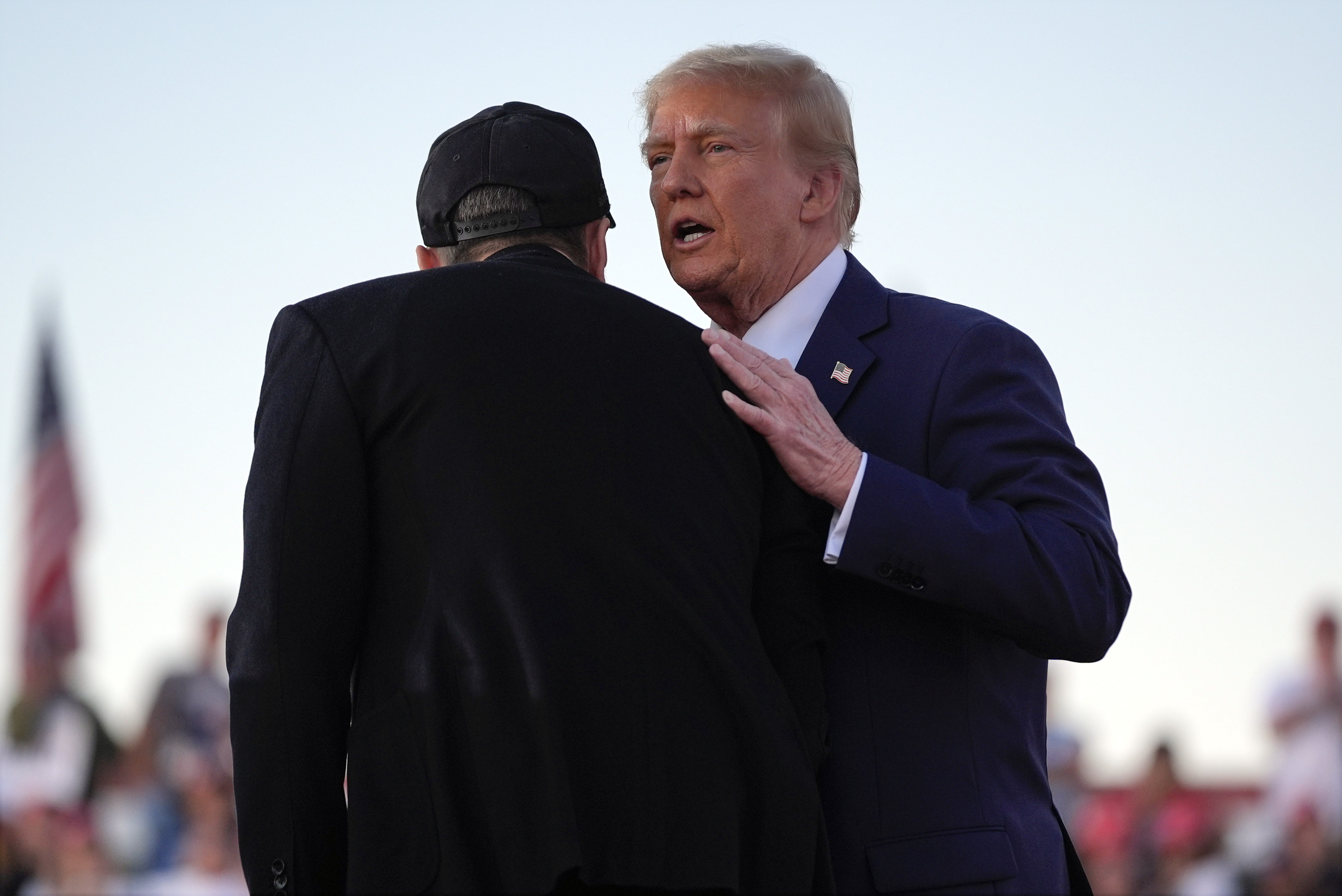 Republican presidential nominee former President Donald Trump shakes hands with Elon Musk at a campaign rally at the Butler Farm Show, Saturday, Oct. 5, 2024, in Butler, Pa. (AP Photo/Evan Vucci)