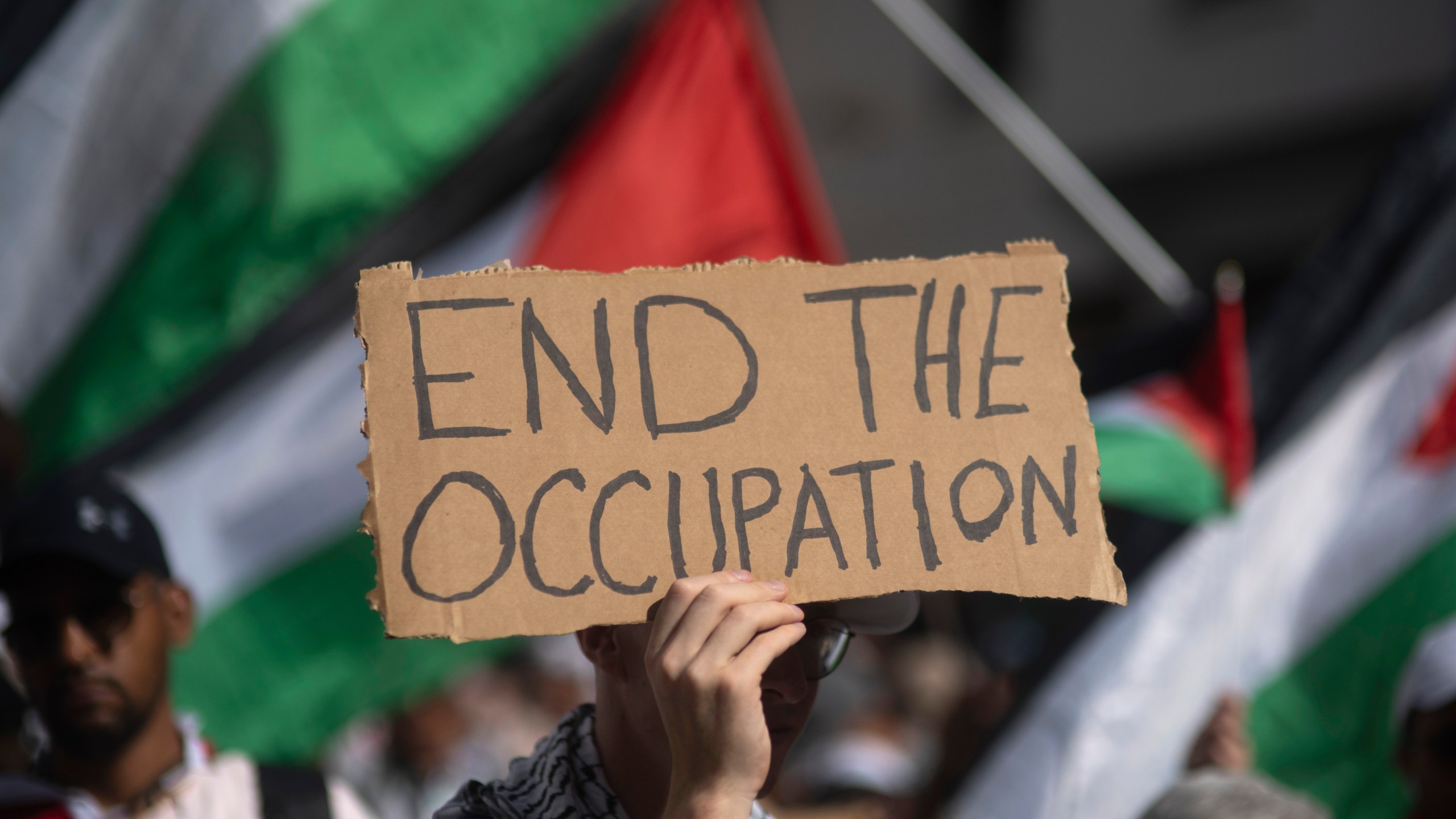 A Moroccan man carries a sign during a protest in support of Gaza and Lebanon, in Rabat, Morocco, Sunday, Oct. 6, 2024 (AP Photo/Mosa'ab Elshamy)