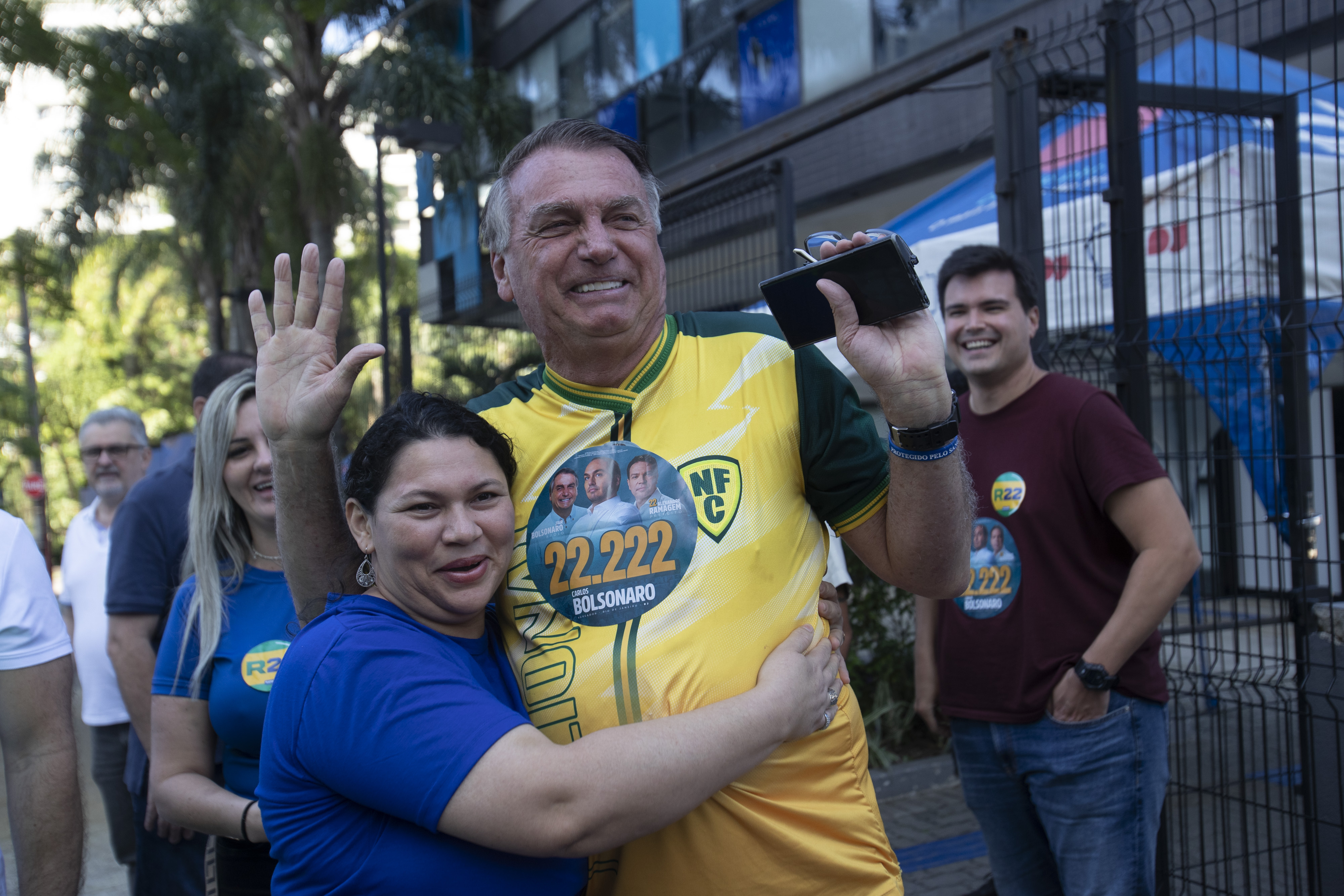 A supporter hugs former Brazilian President Jair Bolsonaro, center, as he supports for Rio de Janeiro mayoral candidate Alexandre Ramagem during municipal elections in Rio de Janeiro, Sunday, Oct. 6, 2024. (AP Photo/Bruna Prado)