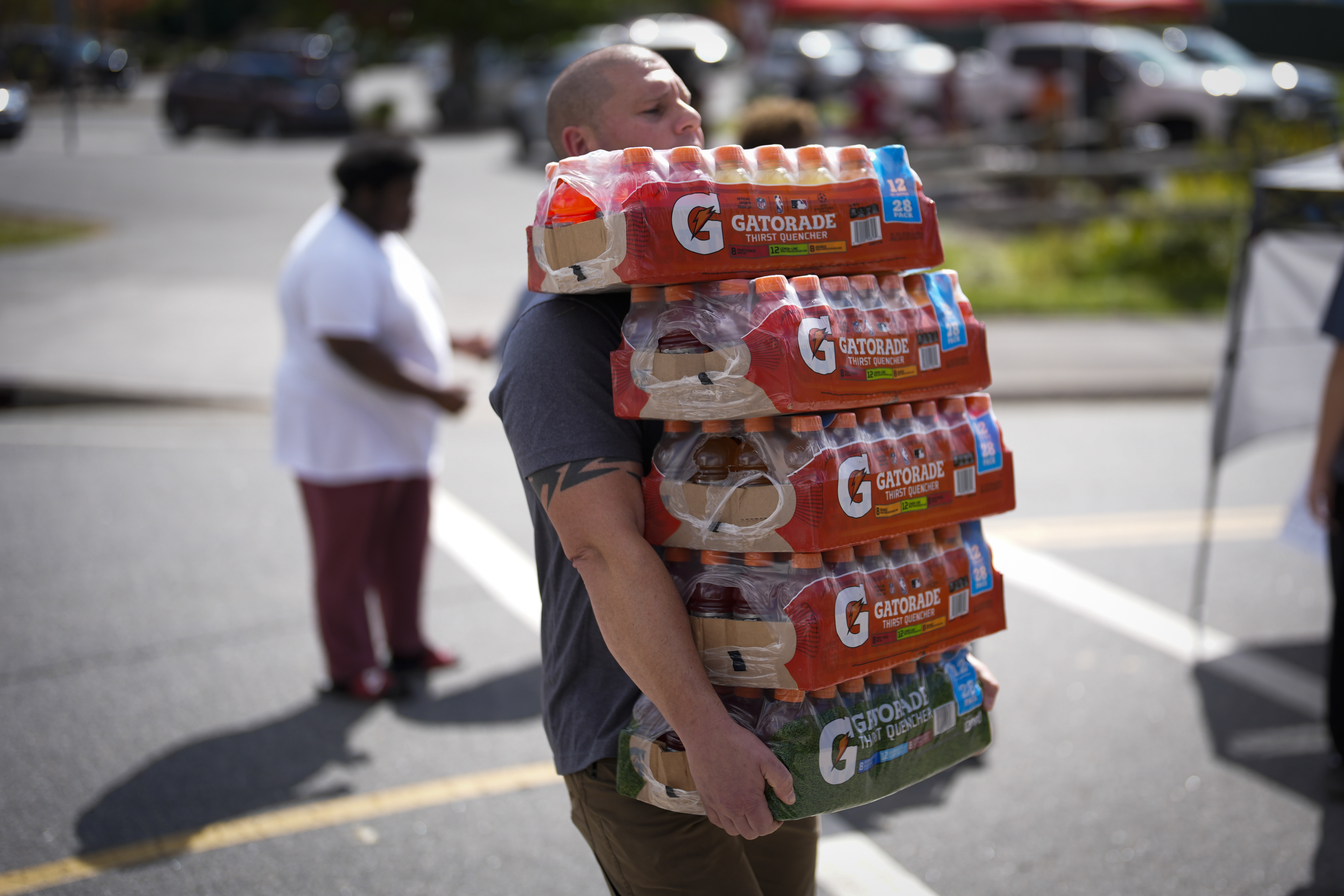 Derek Lisowski unloads supplies at Watauga High School on Thursday, Oct. 3, 2024, in Boone, N.C. in the aftermath of hurricane Helene. In the final weeks of the presidential election, people in North Carolina and Georgia, influential swing states, are dealing with more immediate concerns: recovering from Hurricane Helene. (AP Photo/Chris Carlson)