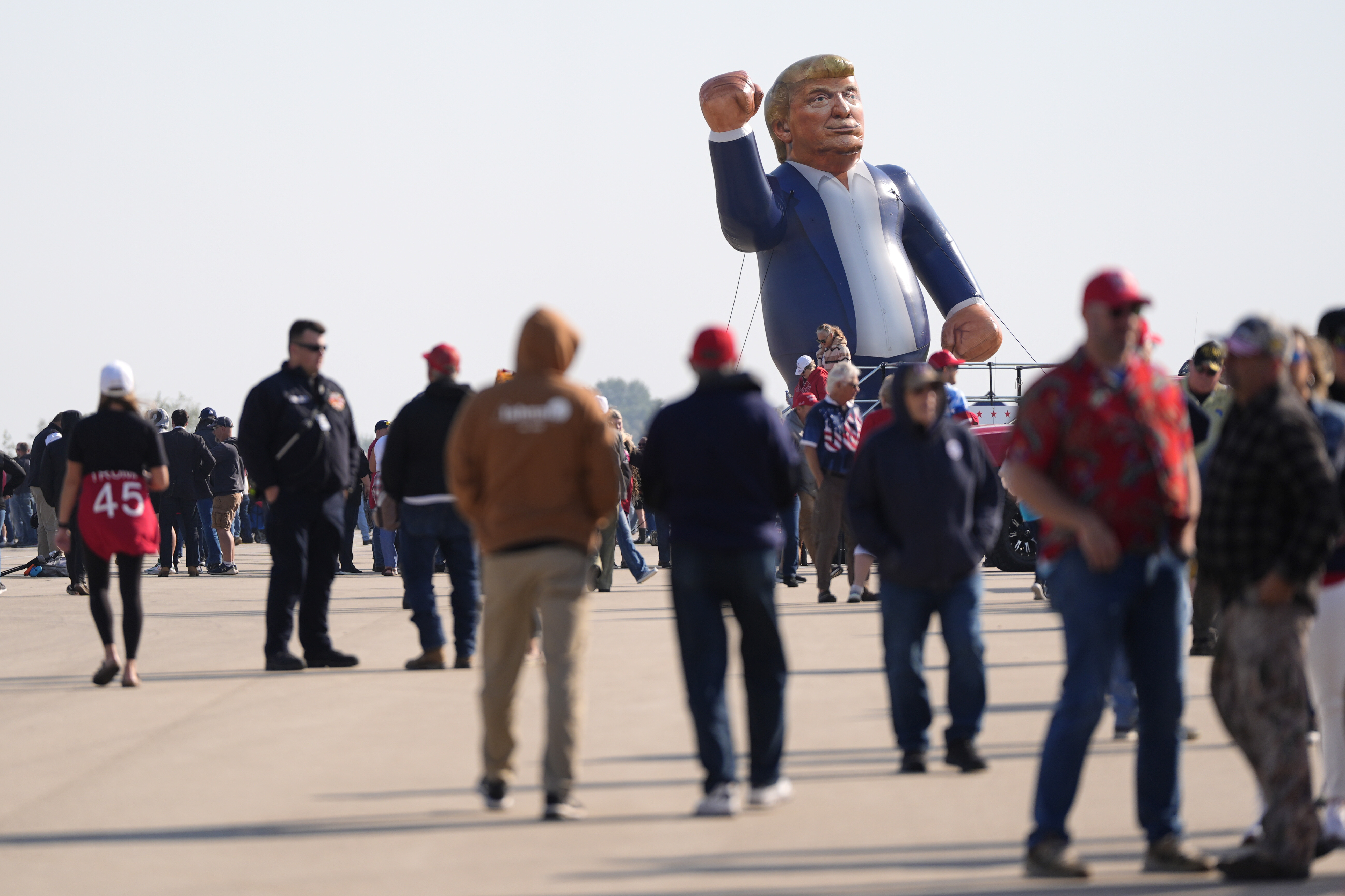 An inflatable Donald Trump is pictured in the parking lot of a campaign rally for the Republican presidential nominee former President as attendees arrive at Dodge County Airport, Sunday, Oct. 6, 2024, in Juneau, Wis. (AP Photo/Julia Demaree Nikhinson)