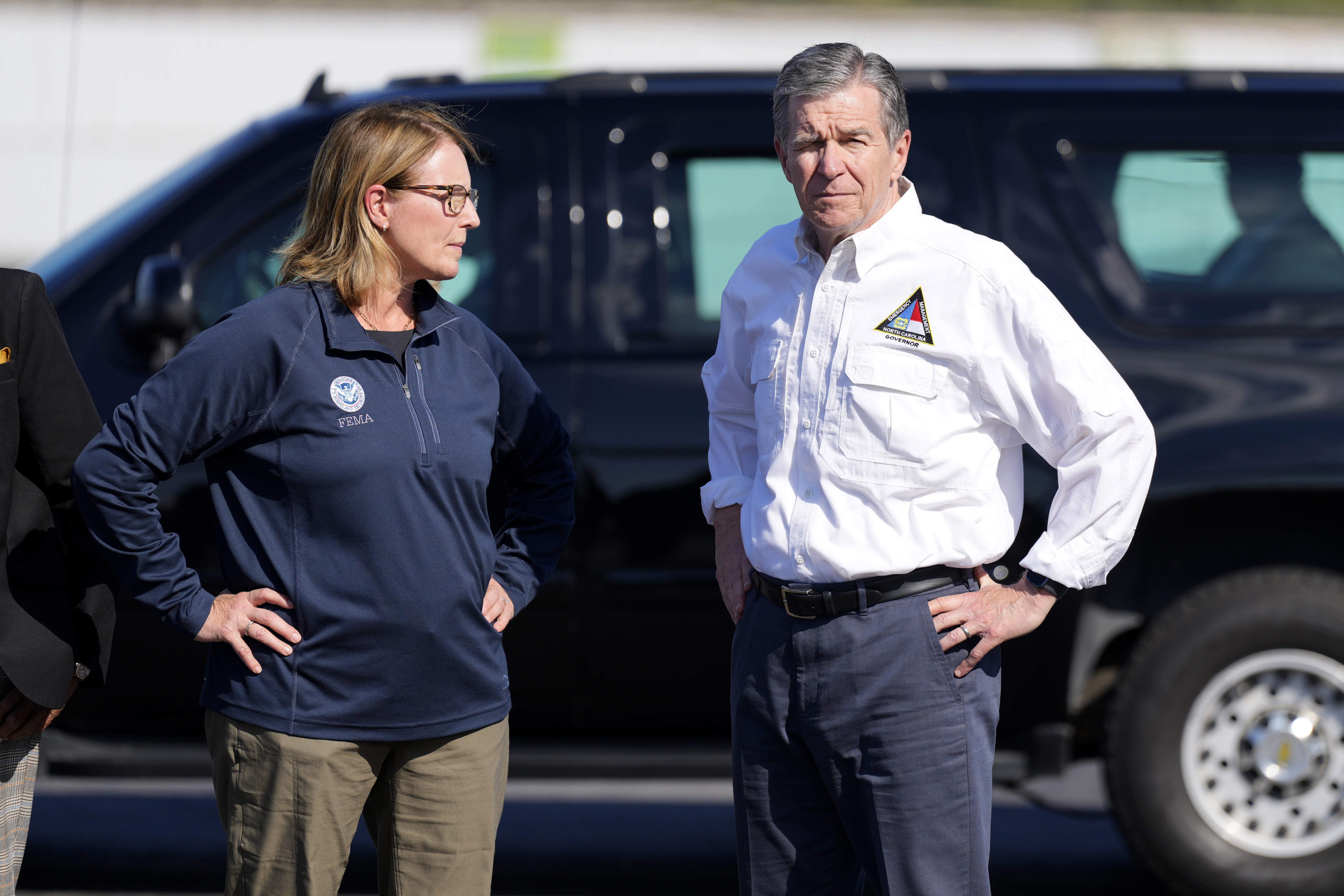 North Carolina Gov. Roy Cooper, right, and Deanne Criswell, Administrator of the U.S. Federal Emergency Management Agency, await the arrival of Democratic presidential nominee Vice President Kamala Harris for a briefing on the damage from Hurricane Helene, at Charlotte Douglas International Airport, Saturday, October 5, 2024, in Charlotte, N.C. (AP Photo/Chris Carlson)