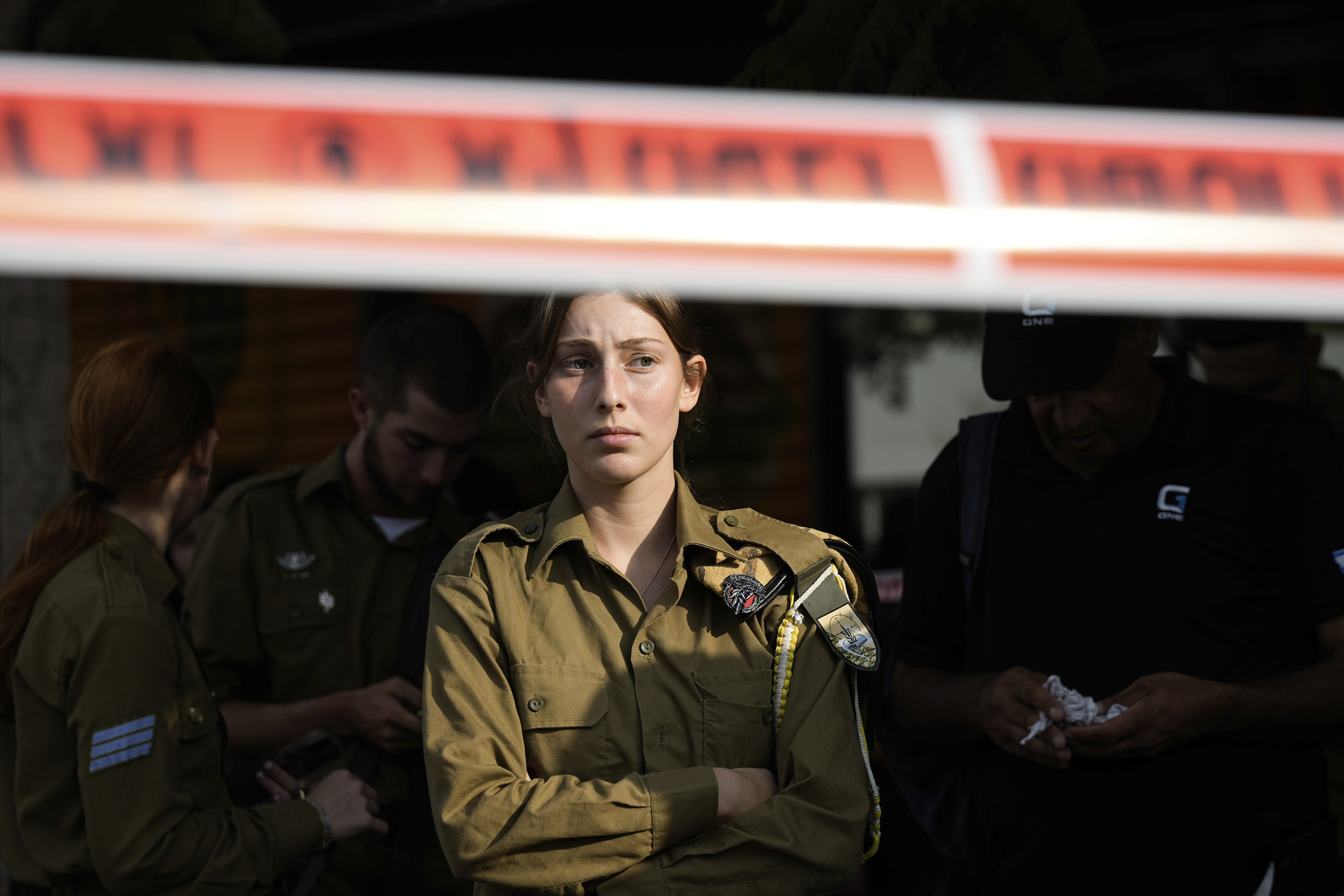 An Israeli soldier looks at the scene of a stabbing and shooting attack where Israel's Magen David Adom rescue service said one person was killed and several others were wounded in Beersheba, Israel, Sunday, Oct. 6, 2024. (AP Photo/Tsafrir Abayov)