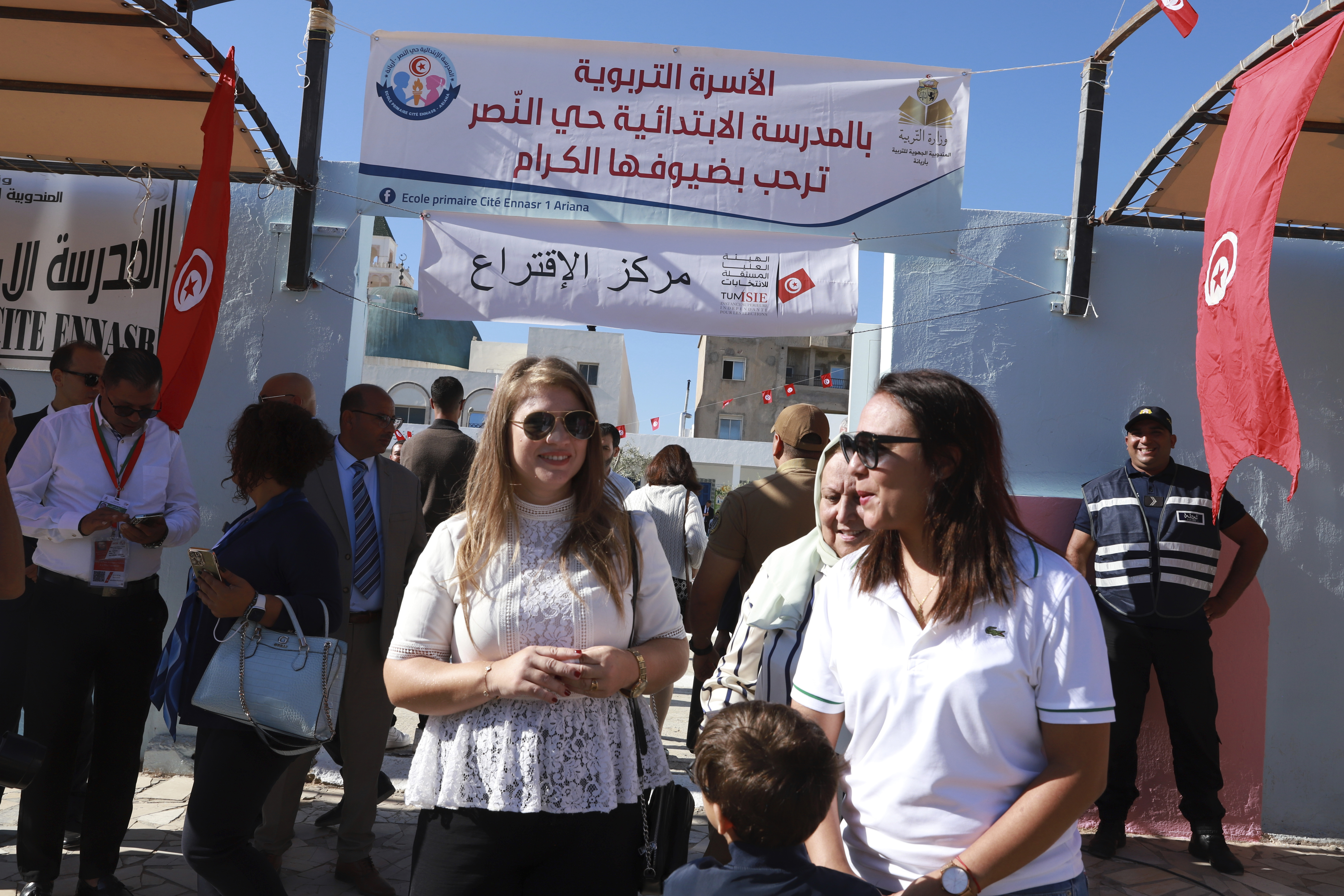 Voters and officials gather outside a polling station during the presidential elections, in the capital Tunis, Tunisia, Sunday, Oct. 6, 2024. (AP Photo/Anis Mili)