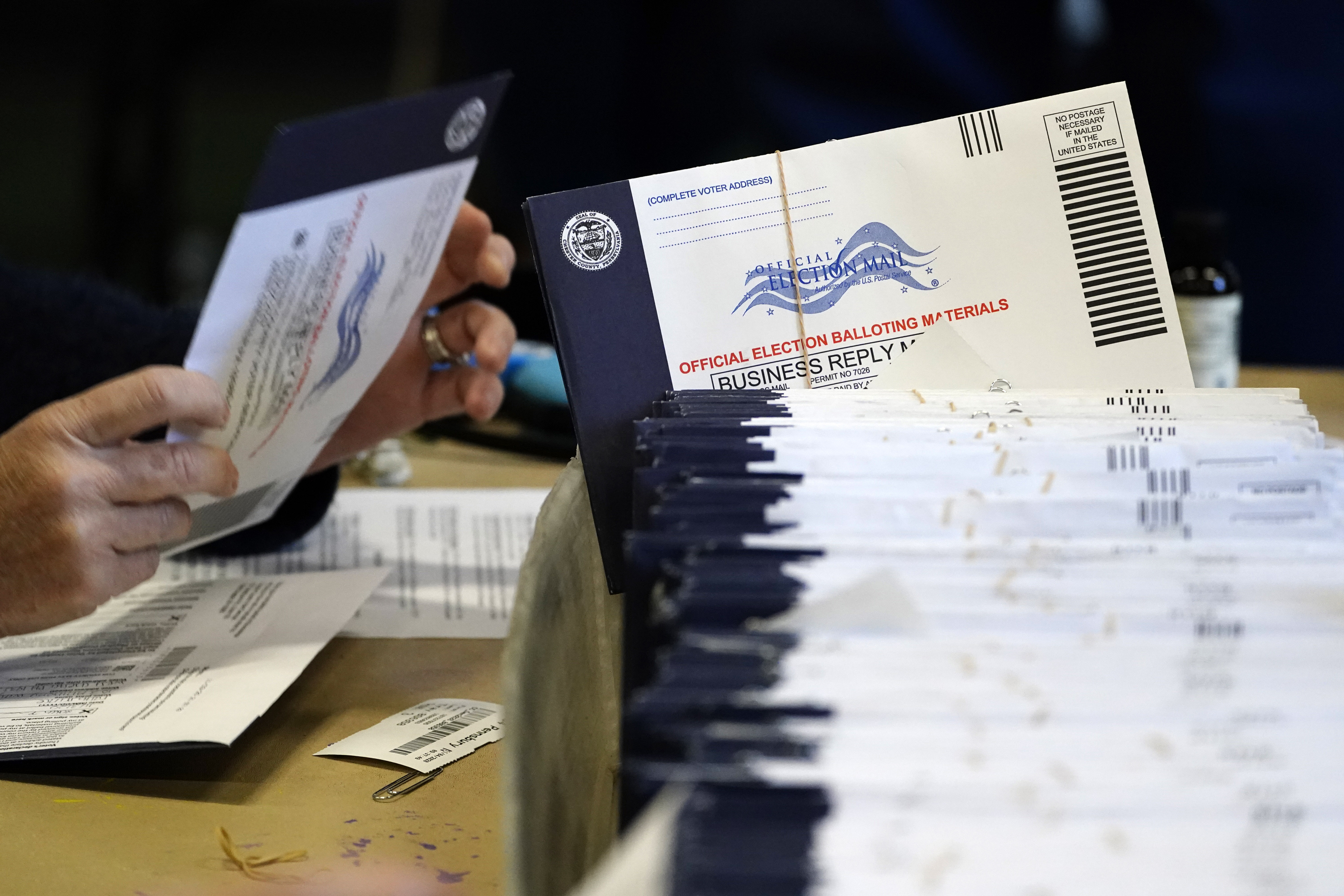 FILE - Chester County, Pa., election workers process mail-in and absentee ballots, in West Chester, Pa., Nov. 4, 2020. (AP Photo/Matt Slocum, File)