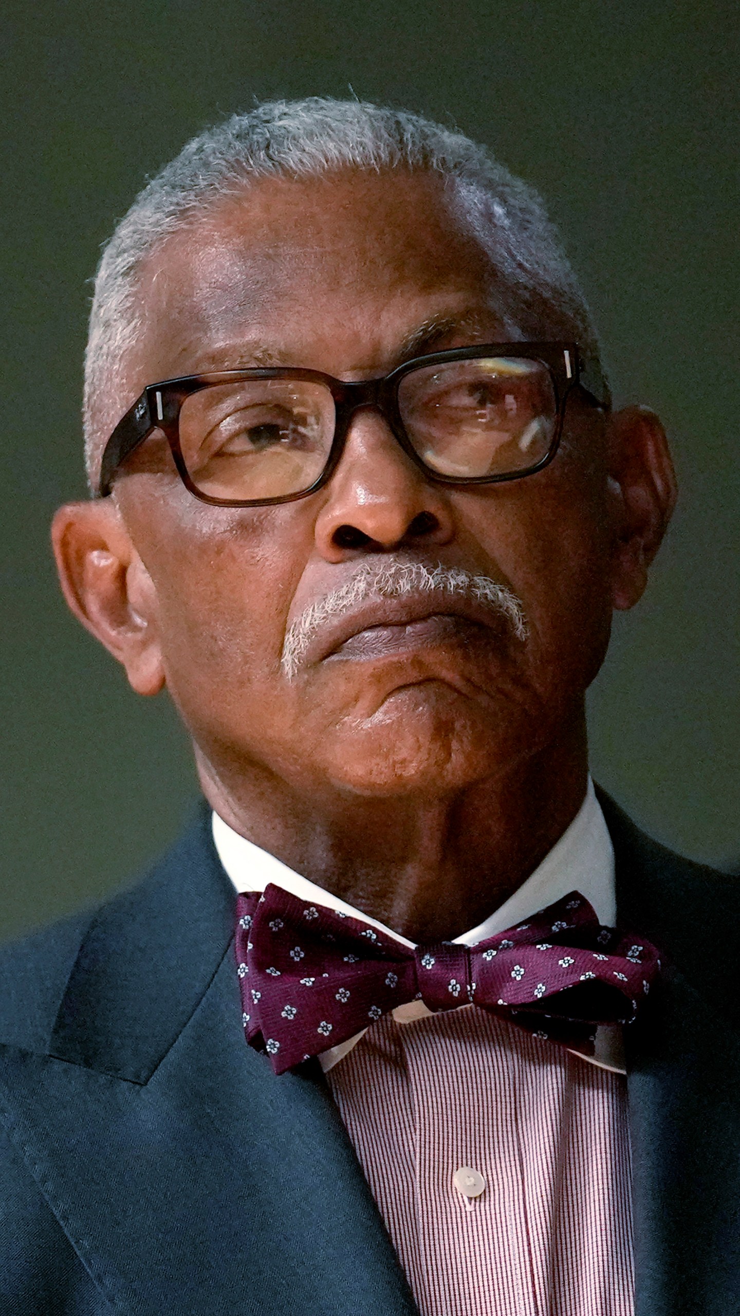 Frank Niles Thomas, one of six nominees by Chicago Mayor Brandon Johnson to the Chicago Board of Education listens to the mayor during a news conference introducing his nominees Monday, Oct. 7, 2024, in Chicago. (AP Photo/Charles Rex Arbogast)