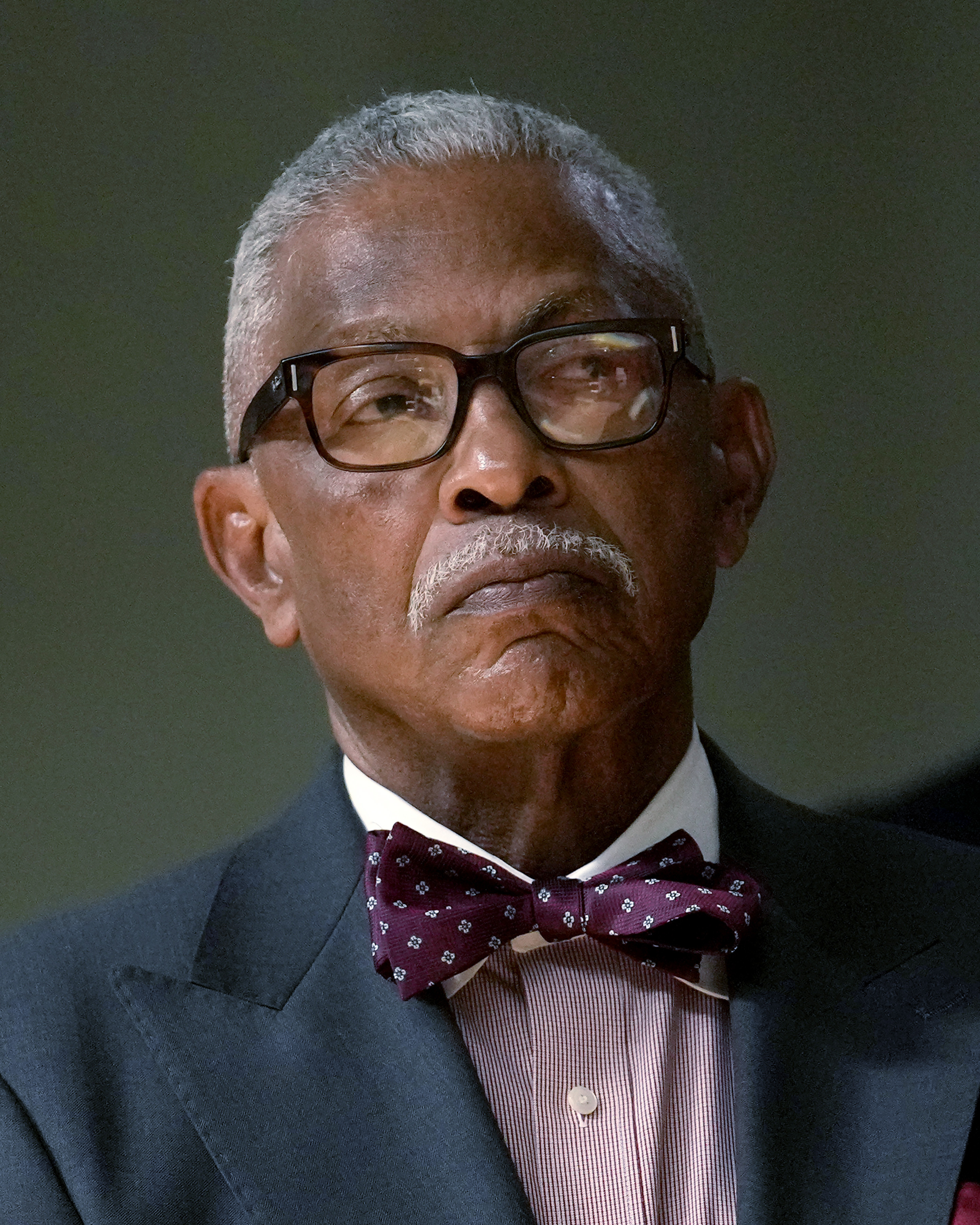 Frank Niles Thomas, one of six nominees by Chicago Mayor Brandon Johnson to the Chicago Board of Education listens to the mayor during a news conference introducing his nominees Monday, Oct. 7, 2024, in Chicago. (AP Photo/Charles Rex Arbogast)