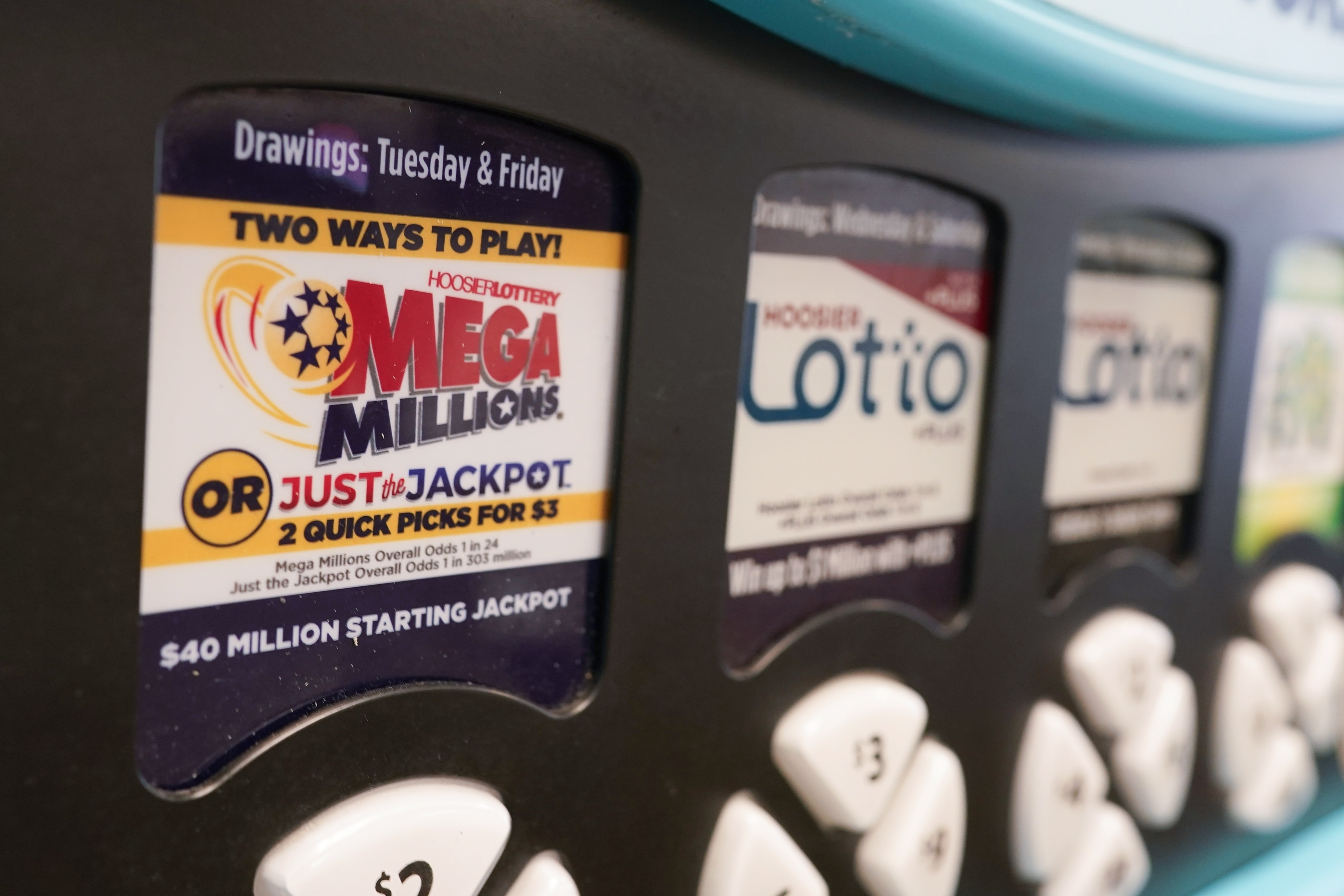 FILE - A Mega Millions logo is displayed on a vending machine at the Hoosier Lottery booth at the Indiana State Fair, Thursday, Aug. 3, 2023, in Indianapolis. (AP Photo/Darron Cummings, File)