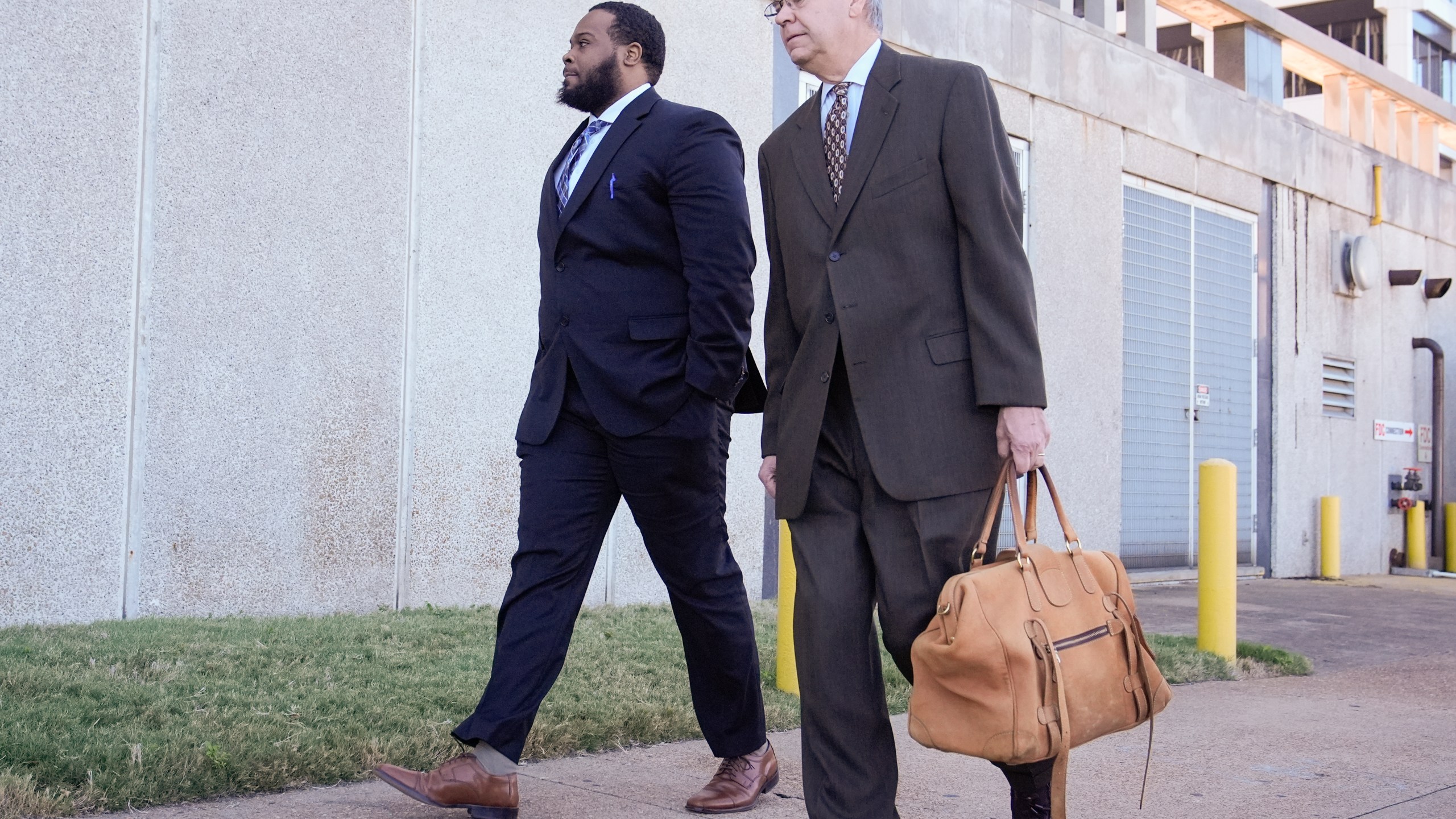 Demetrius Haley, left, one of three former Memphis police officers charged in the 2023 fatal beating of Tyre Nichols, arrives at the federal courthouse with his attorney Michael Stengel, right, for the day's proceedings Thursday, Oct. 3, 2024, in Memphis, Tenn. (AP Photo/George Walker IV)