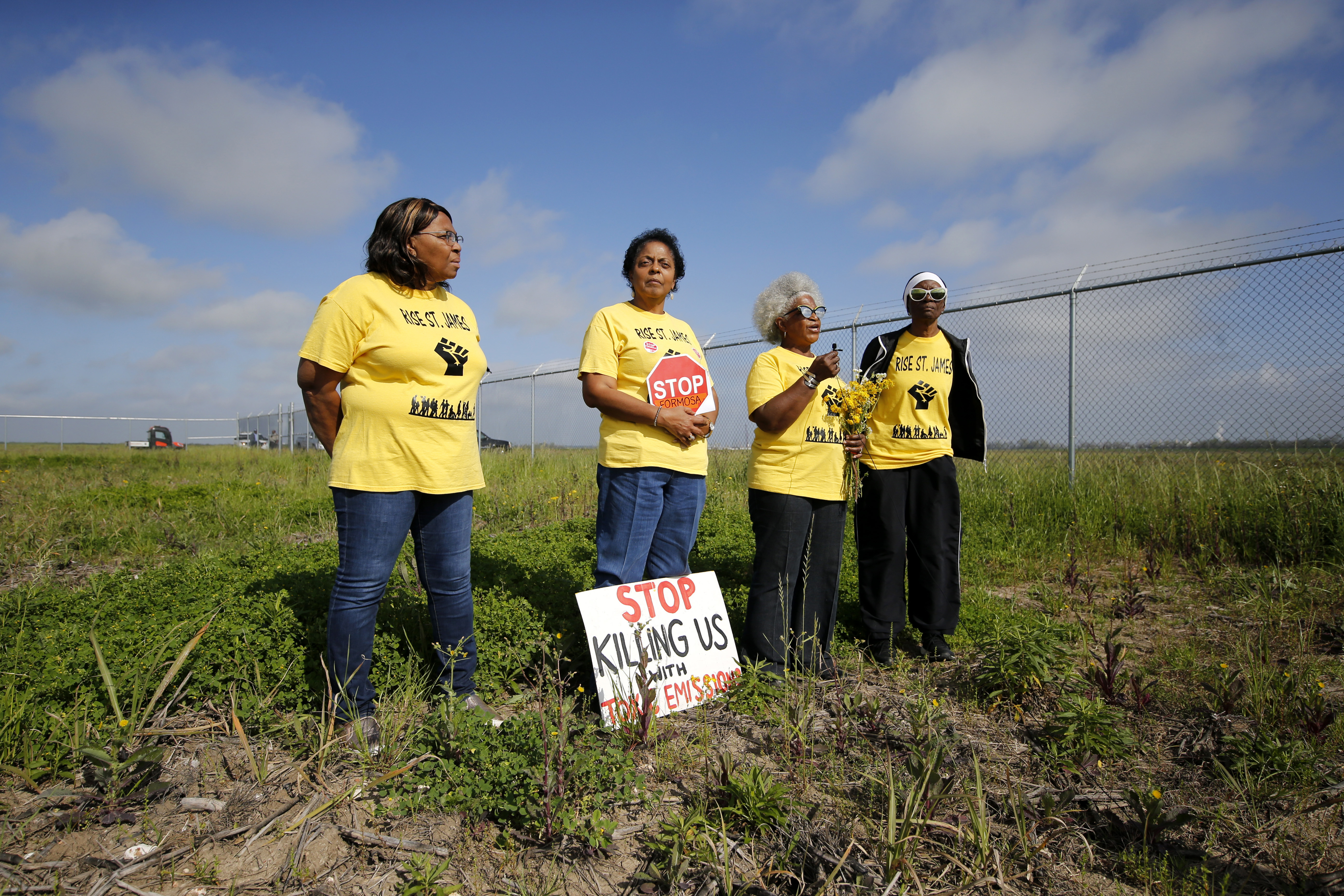 FILE - From left, Myrtle Felton, Sharon Lavigne, Gail LeBoeuf and Rita Cooper, members of RISE St. James, conduct a live stream video on property owned by Formosa in St. James Parish, La., Wednesday, March 11, 2020. (AP Photo/Gerald Herbert, File)