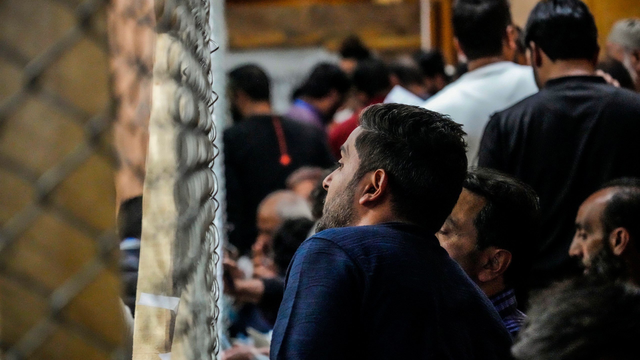 A political party representative watches as polling officials count the votes in the recent election for a local government in Indian-controlled Kashmir on the outskirts of Srinagar, Tuesday, Oct. 8, 2024. (AP Photo/Mukhtar Khan)