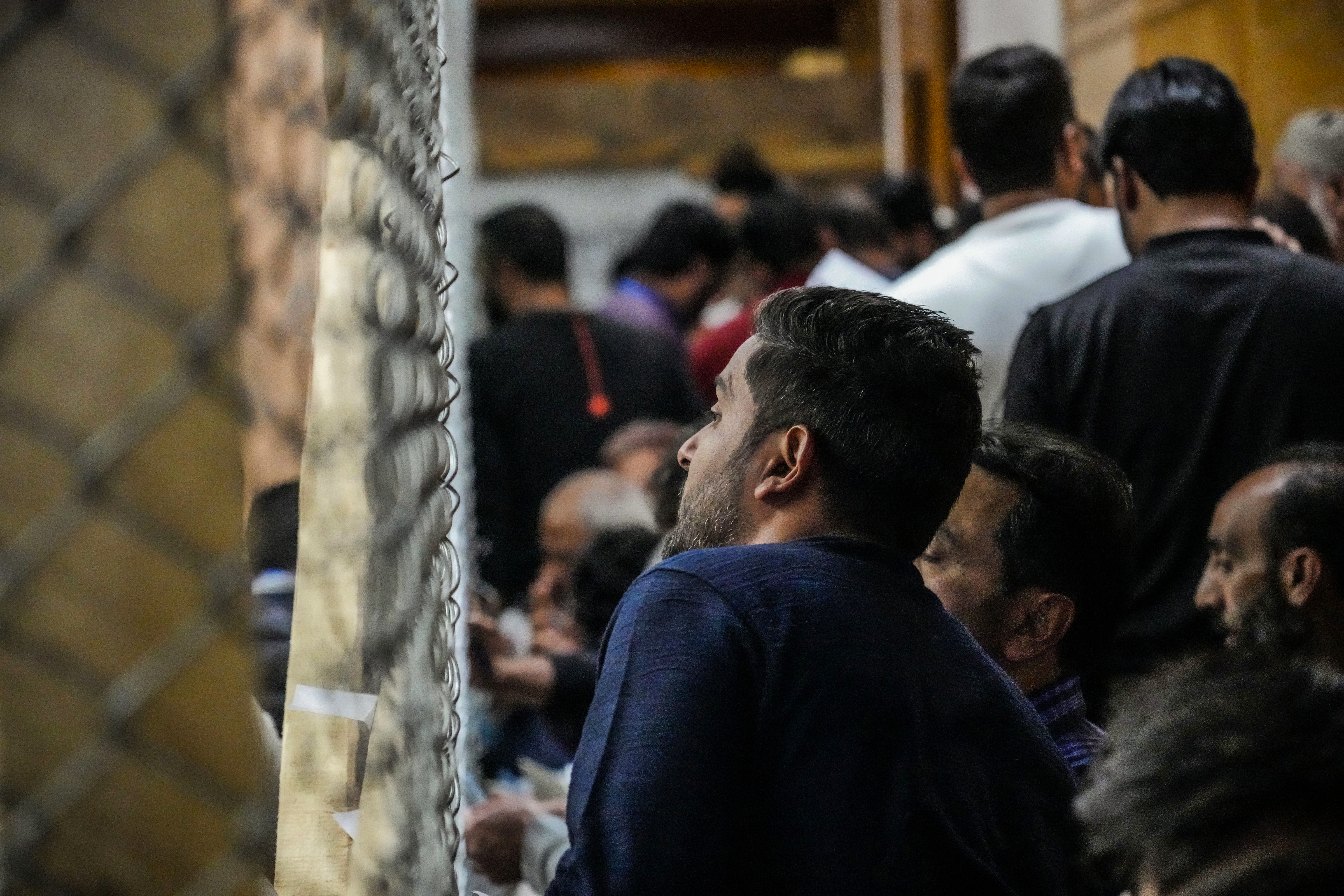 A political party representative watches as polling officials count the votes in the recent election for a local government in Indian-controlled Kashmir on the outskirts of Srinagar, Tuesday, Oct. 8, 2024. (AP Photo/Mukhtar Khan)