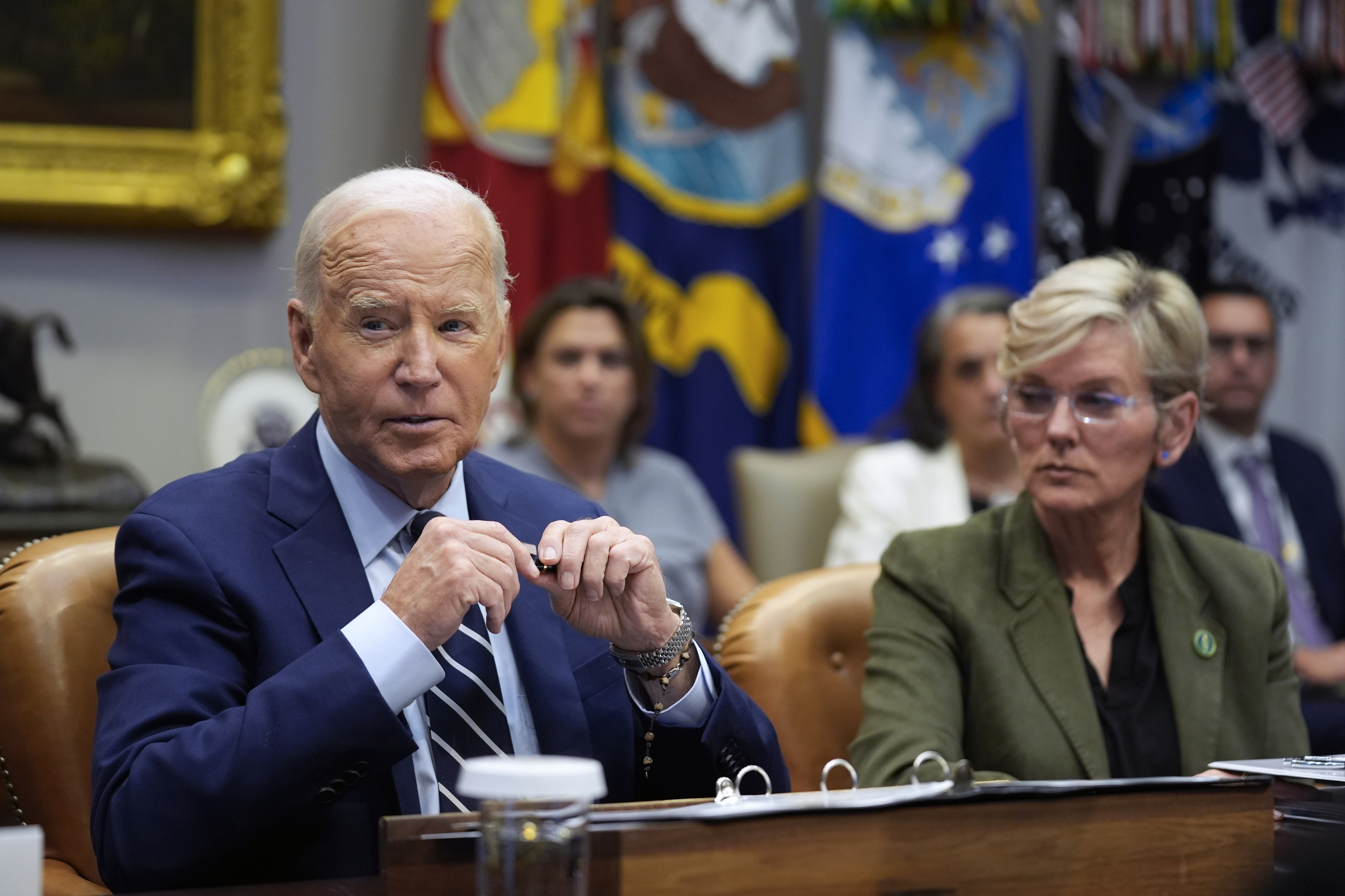 President Joe Biden delivers remarks on the federal government's response to Hurricane Helene and preparations for Hurricane Milton in the Roosevelt Room of the White House, Tuesday, Oct. 8, 2024, in Washington, as Secretary of Energy Jennifer Granholm looks on. (AP Photo/Evan Vucci)