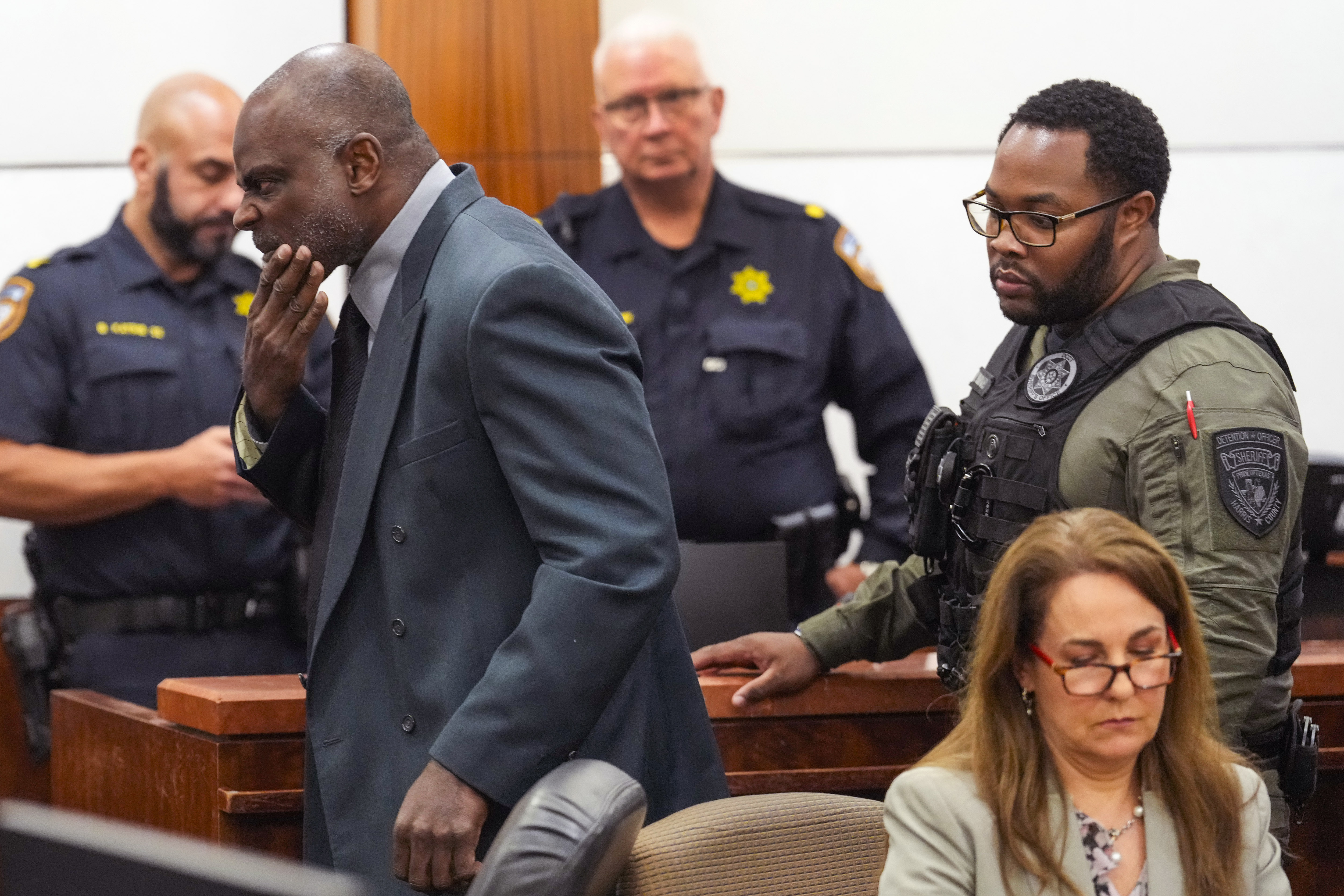 Former Houston police officer Gerald Goines is led through the courtroom by deputies after he was sentenced to 60 years behind bars on a pair of felony murder convictions on Tuesday, Oct. 8, 2024, in Houston. Goines was found guilty of felony murder in the 2019 deaths of Dennis Tuttle and Rhogena Nicholas. (Brett Coomer/Houston Chronicle via AP)