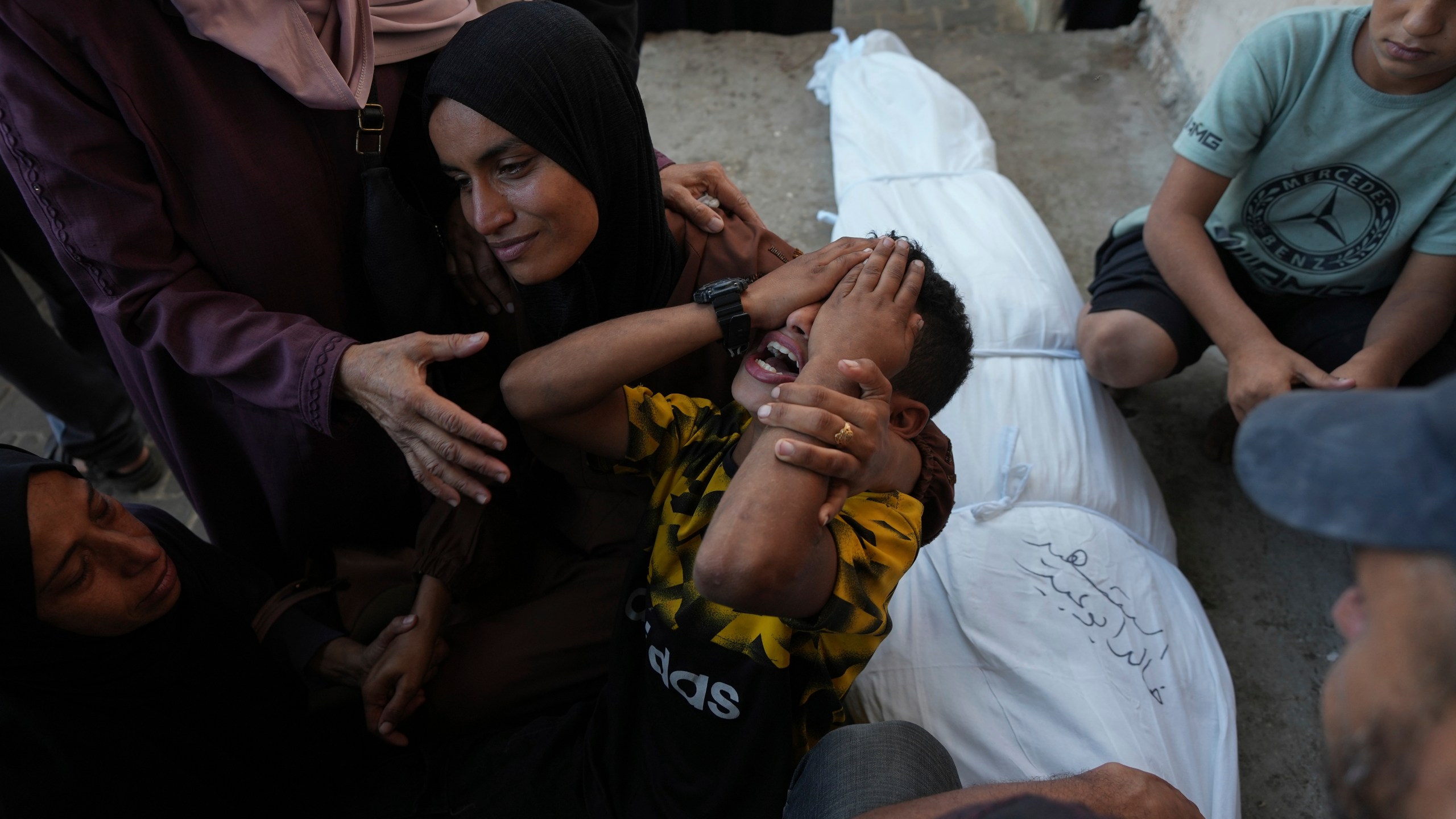 Mourners attend the funeral of Palestinians killed in the Israeli bombardment of the Gaza Strip outside the hospital morgue in Deir al-Balah on Wednesday, Oct. 9, 2024. (AP Photo/Abdel Kareem Hana)