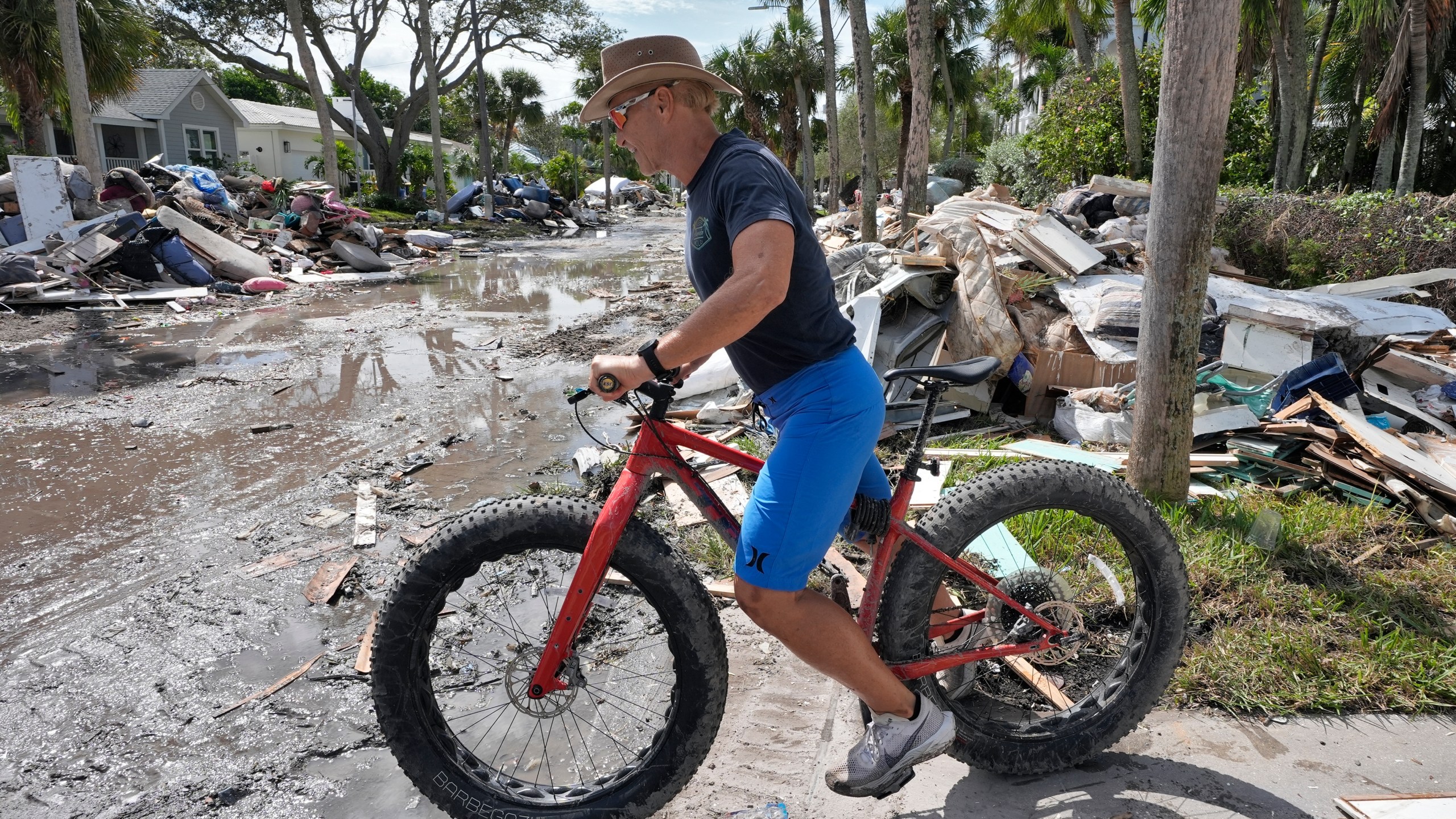 FILE - Arnie Bellini surveys the damages caused from Hurricane Helene on a street in Clearwater Beach, Fla., Oct. 8, 2024. (AP Photo/Chris O'Meara, File)