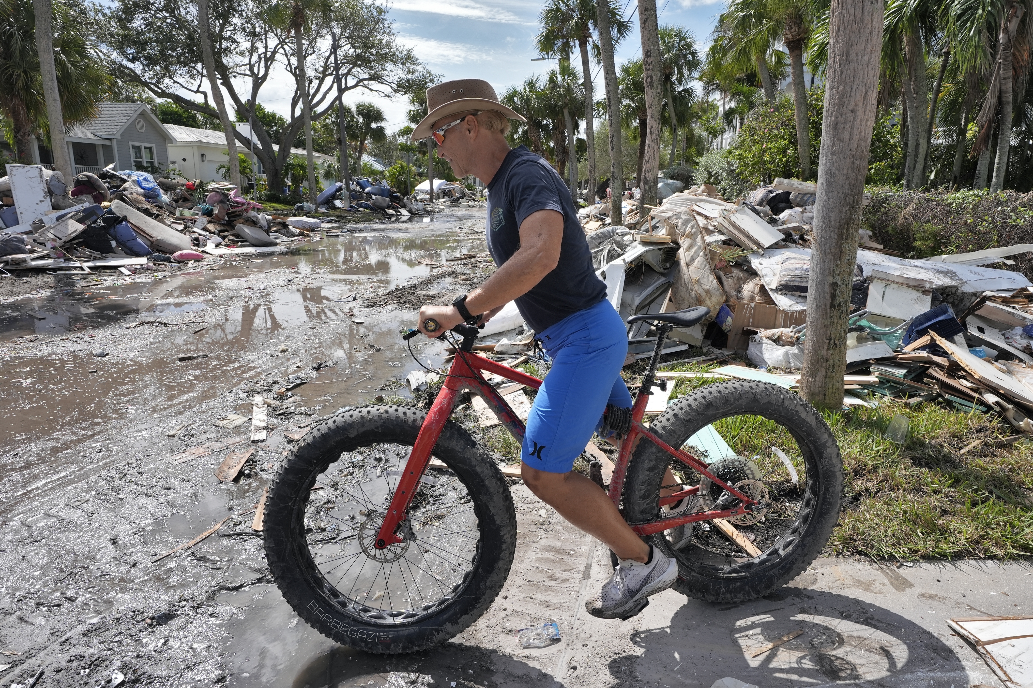 FILE - Arnie Bellini surveys the damages caused from Hurricane Helene on a street in Clearwater Beach, Fla., Oct. 8, 2024. (AP Photo/Chris O'Meara, File)