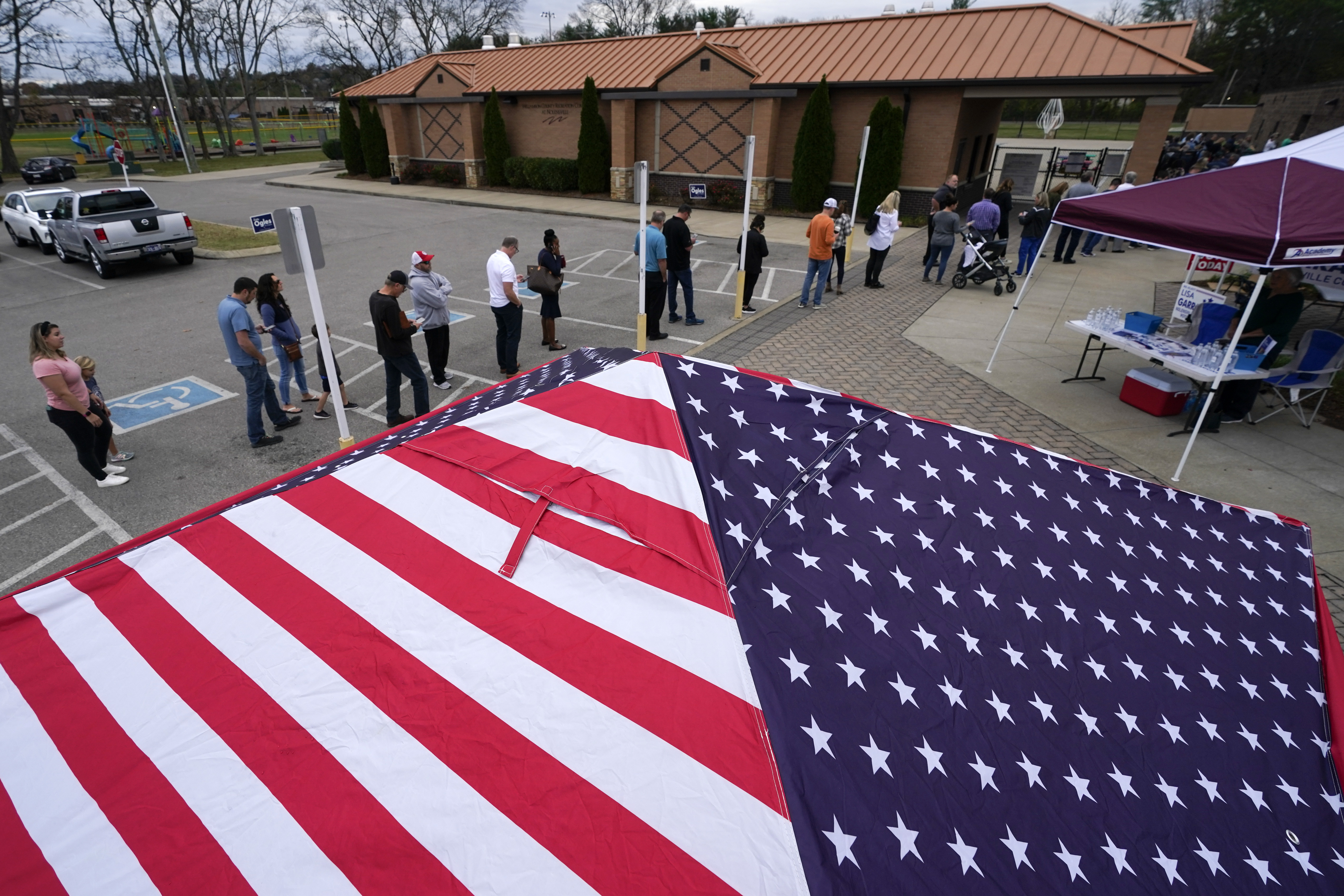 FILE - People line up to vote near tents set up by candidates' supporters, Nov. 8, 2022, in Nolensville, Tenn. (AP Photo/Mark Humphrey, File)